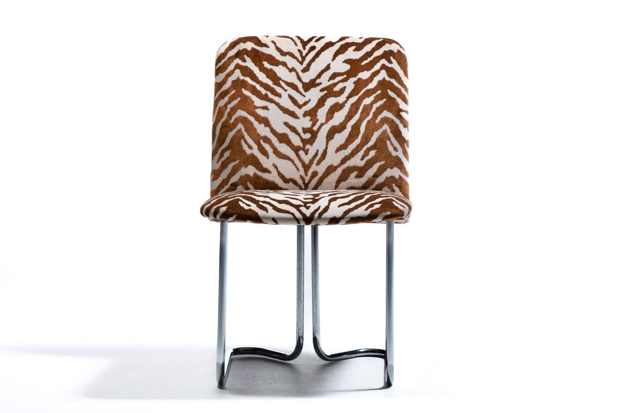Newly professionally upholstered set of twelve 1970s dining chairs produced by Design Institute of America featuring cantilever bent chrome legs. Clean modern look with an ergonomic design that's meant to align guests and keep them comfortable.
