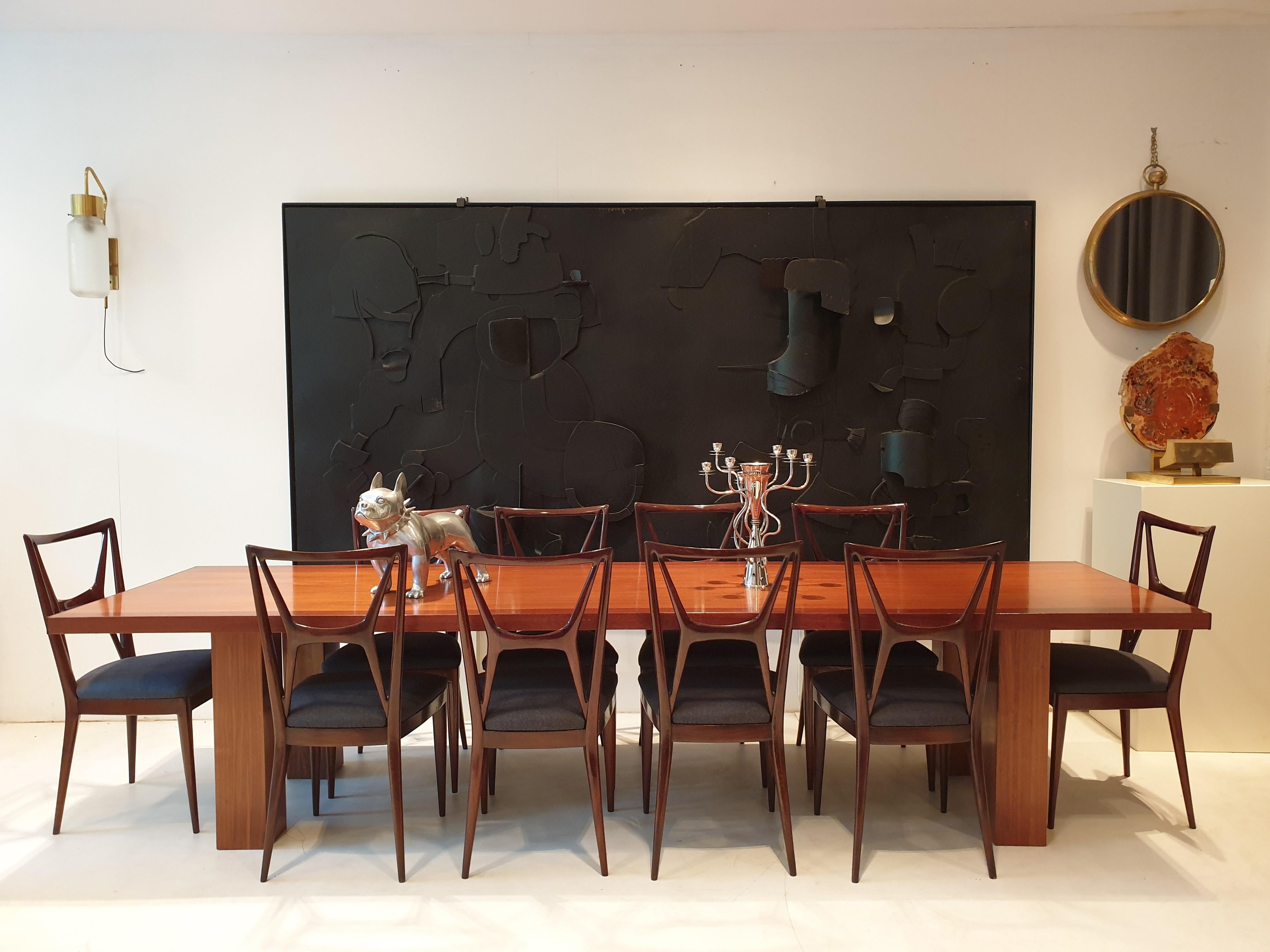 Set of 12 stunning dining chairs attributed to the work of Atelier Apelli and Varesio. Although the form is elegant and pared down, they are still sturdy and very comfortable. They have drop in seats in dark grey woolen fabric so should the