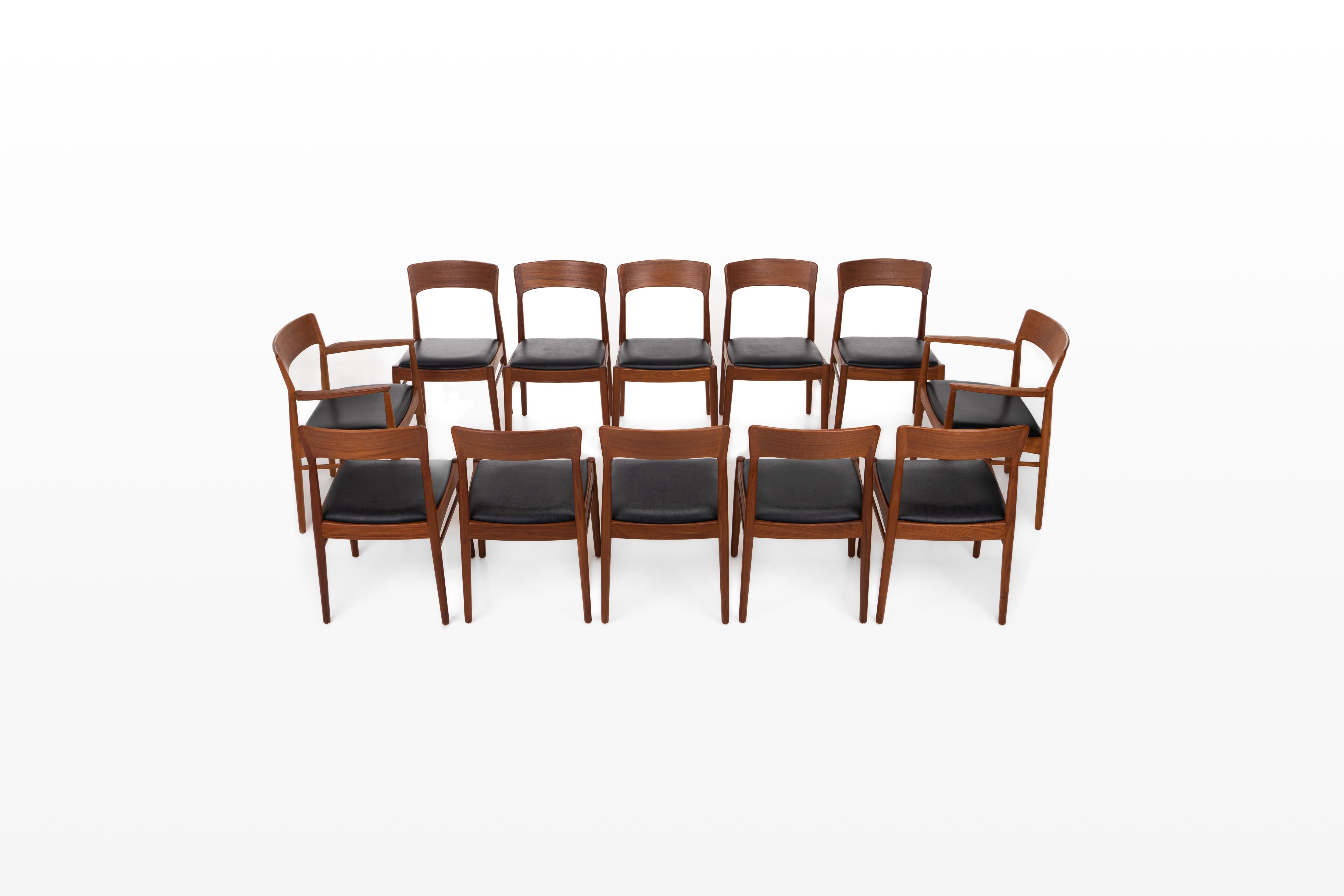 Set of twelve dining chairs in teak, designed by Henning Kjærnulf for Korup Stølefabrik in Denmark in the 1960s. The chairs still have the original black seats.
