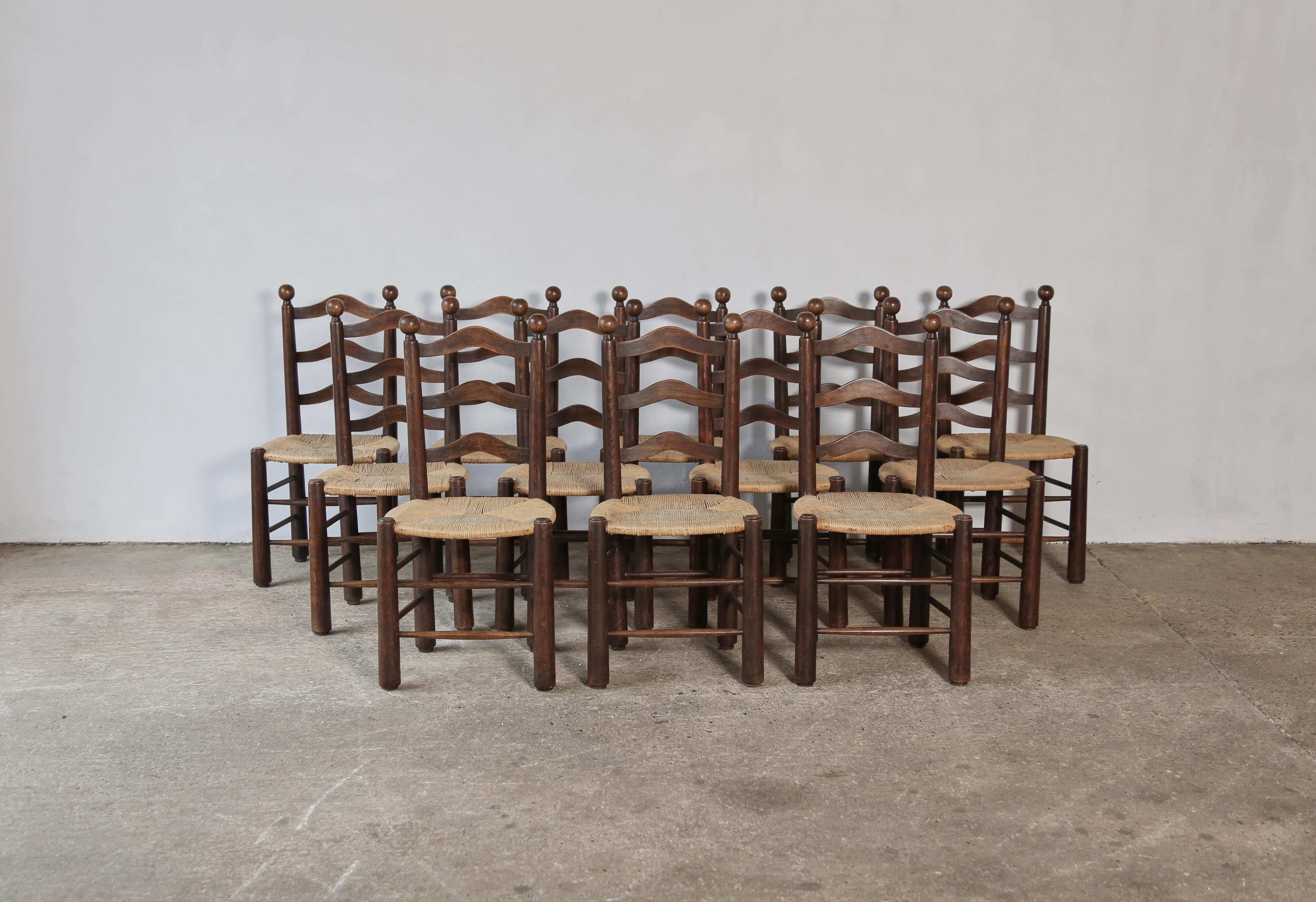 A rare set of twelve dining chairs, attributed to Charles Dudouyt, France, 1950s. Wonderful tapered legs. Good structural condition, ready to use. The wooden frames in original condition with a nice patina and minor signs of use and wear relative to