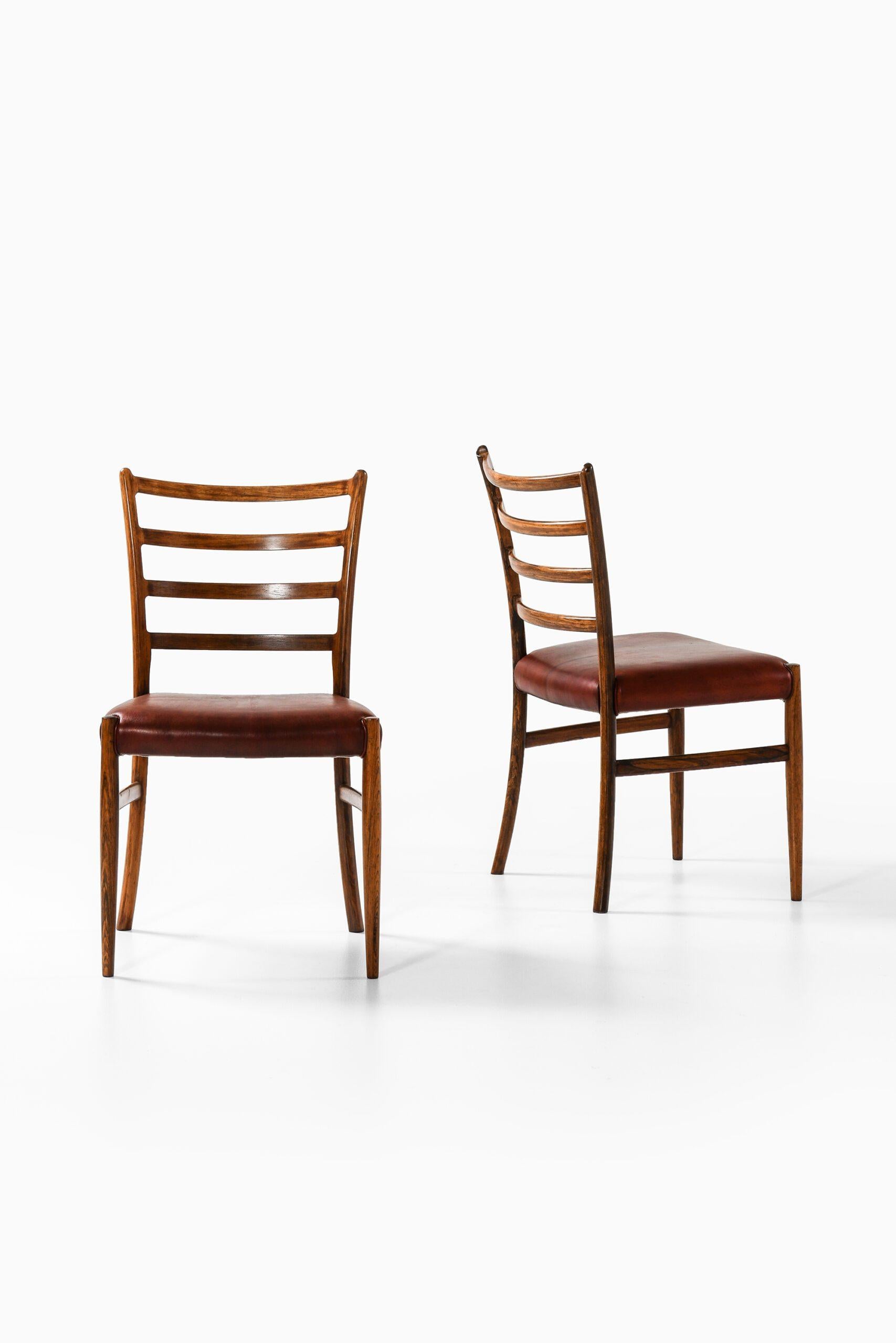 Set of 12 Dining Chairs in Rosewood and Leather, 1960s

Additional Information:
Material: Rosewood and leather
Style: Mid century, Scandinavian
Set of 12 Dining Chairs
Produced in Denmark
Dimensions: 
(W x D x H): 50 x 53 x 84.5 cm, SH: 45 cm