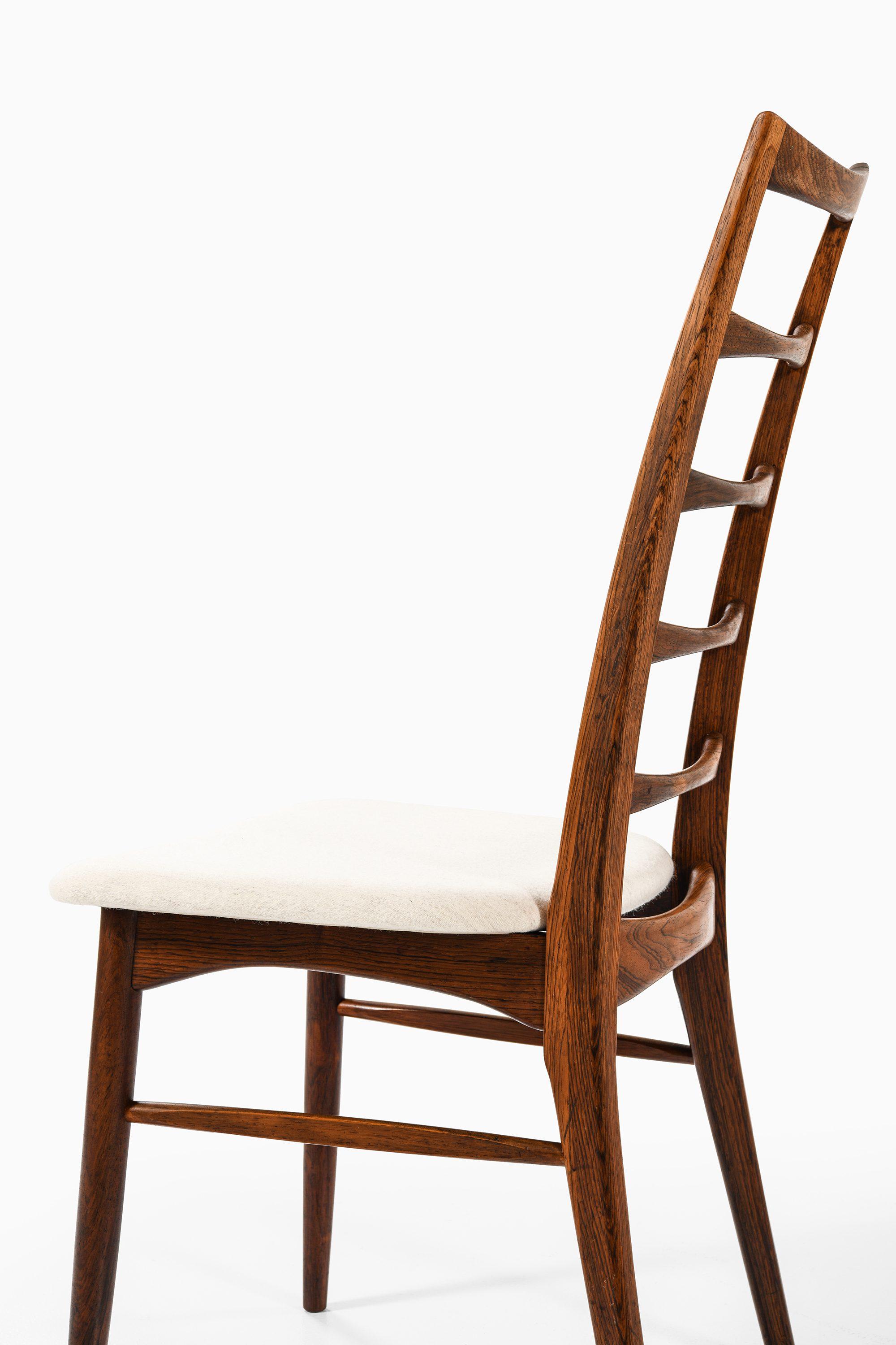 Danois Ensemble de 12 chaises de salle à manger en bois de rose de Niels Kofoed, 1961 en vente
