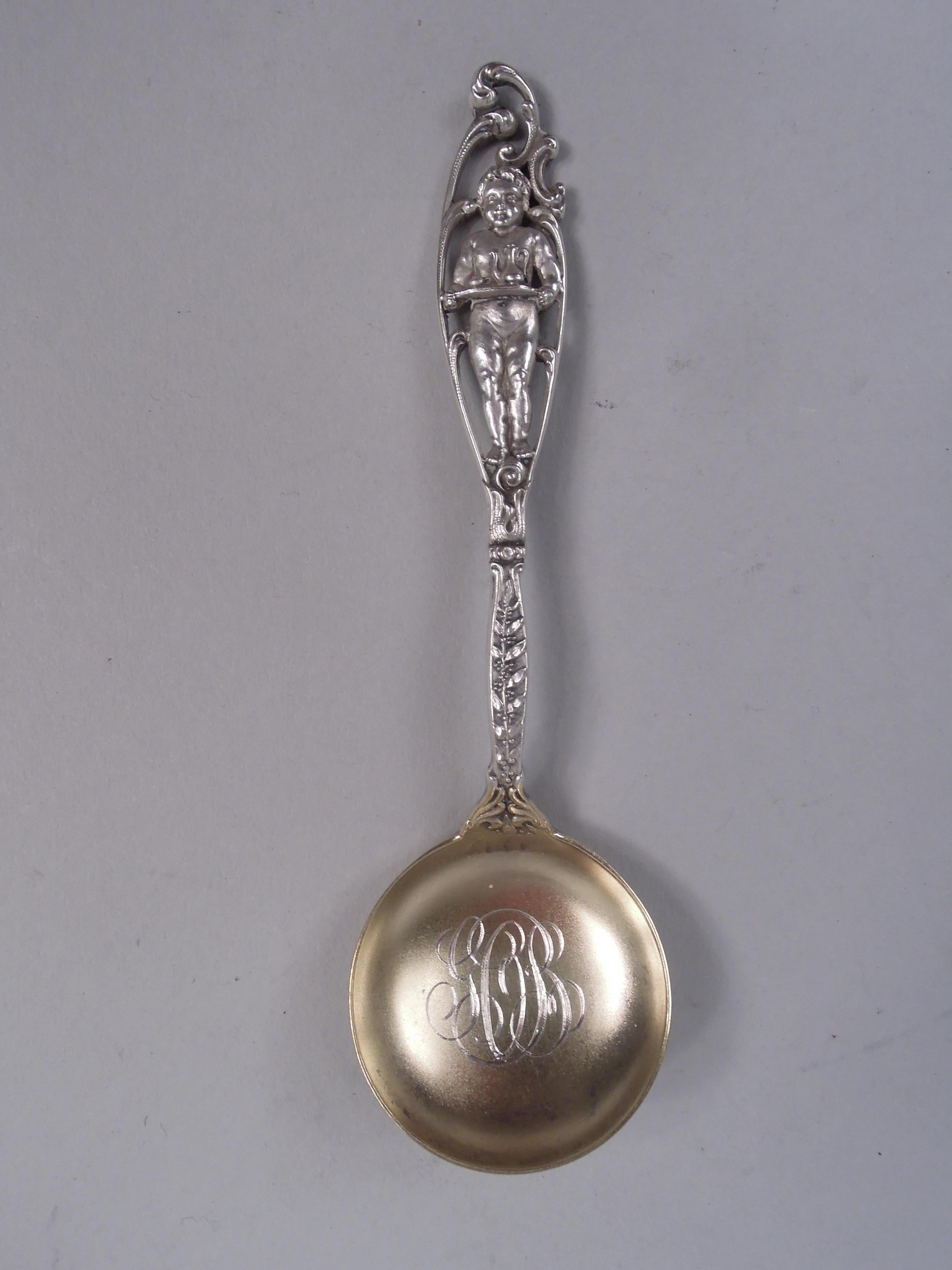 Set of 12 Labors of Cupid sterling silver five o’clock spoons. Made by Dominick & Haff in New York, ca 1900. Early pieces in the pattern that immortalizes the infantine travails of a bare-bottomed cherub in double-sided scrolled terminal. In this