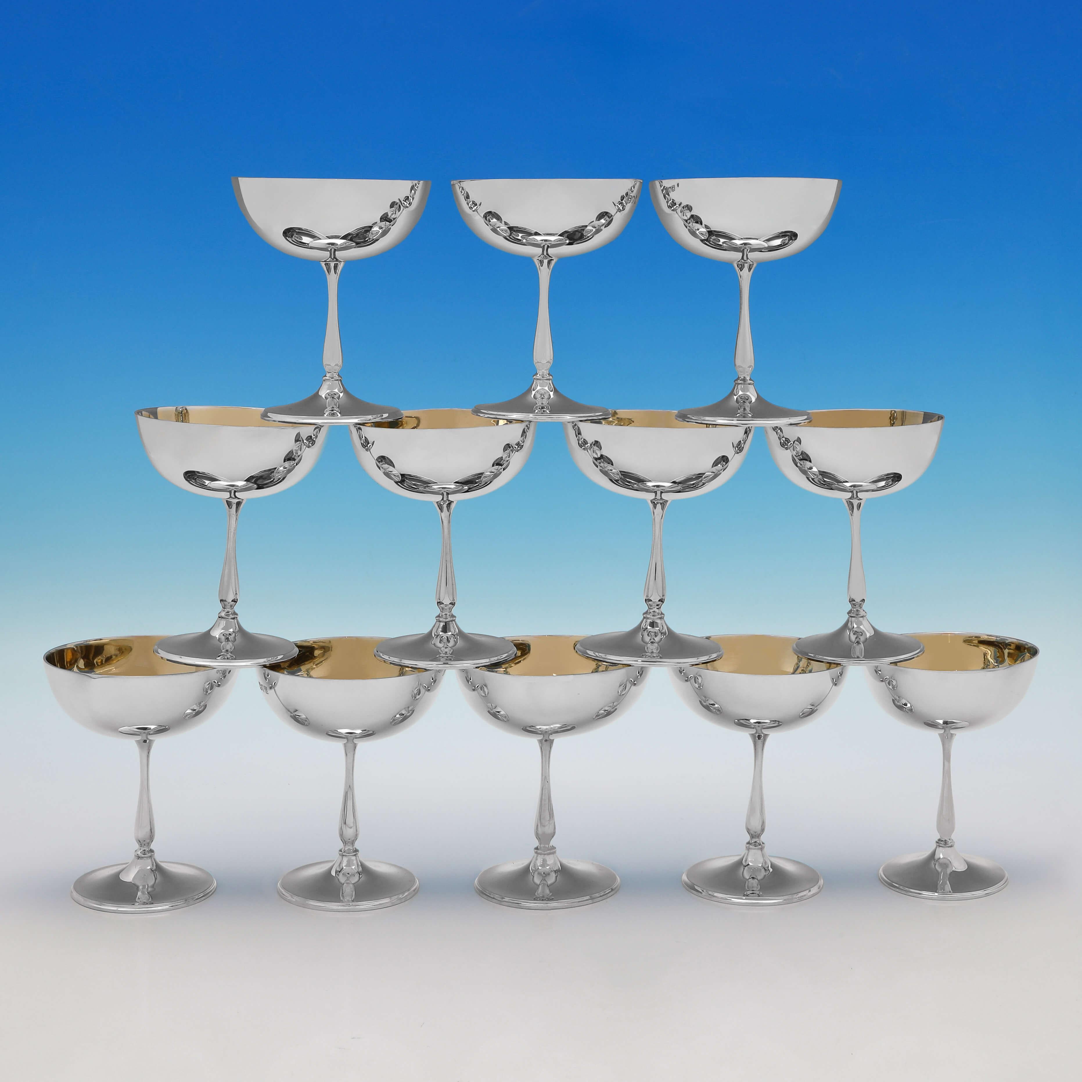 Hallmarked in London in 1901/5 by Edward Barnard & Sons, this very handsome set of 12 Antique Sterling Silver Champagne Coupes, are presented in their original box, and are plain in design with gilt interiors. Each champagne coupe measures