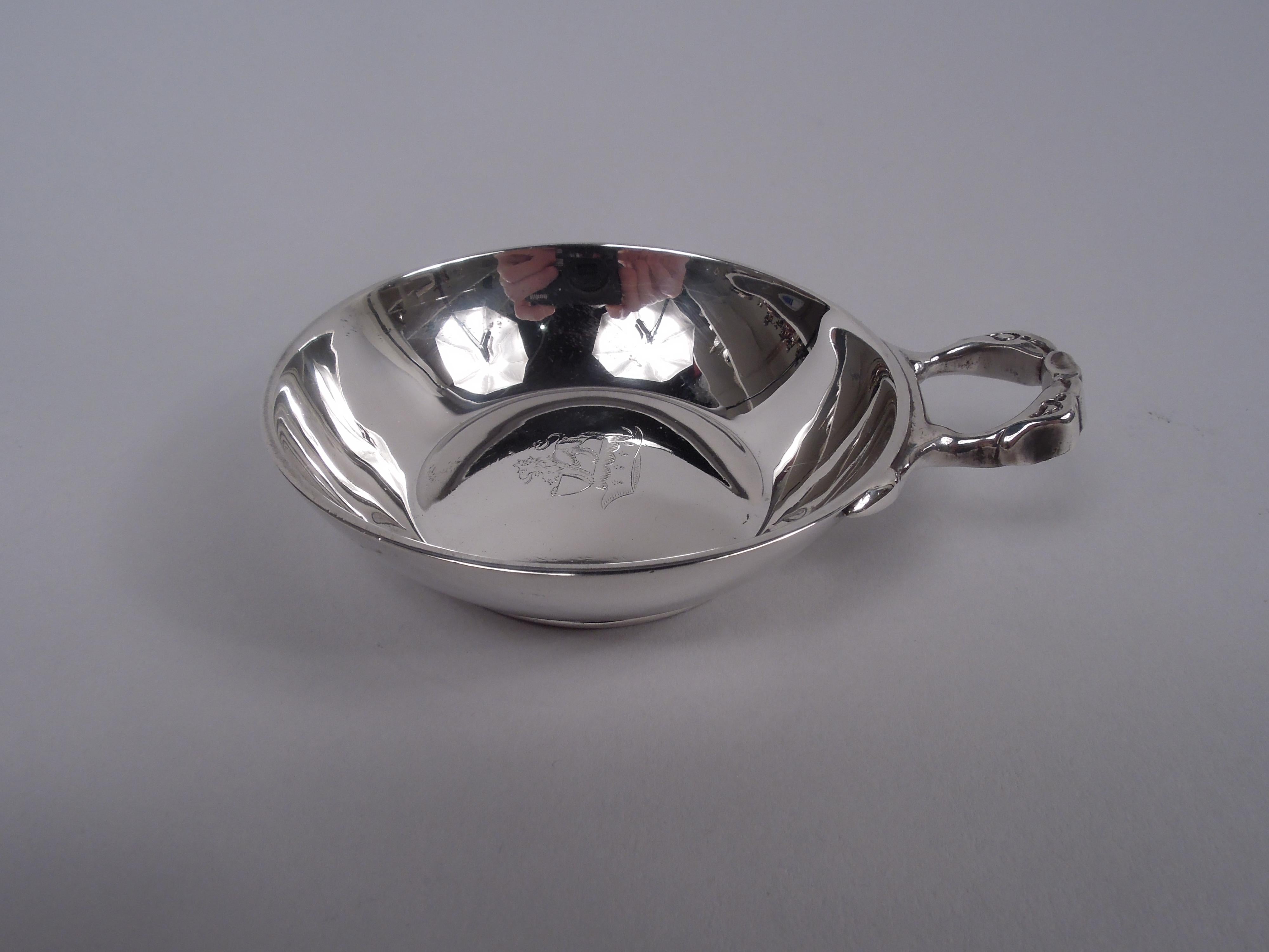 Set of 12 English Modern sterling silver wine tasters, 1930. Each: Curved and tapering sides and snakehead ring handle. Engraved armorial in well. For a tiddly night with all your swanky aristo chums. Fully marked including maker’s stamps (Tessiers