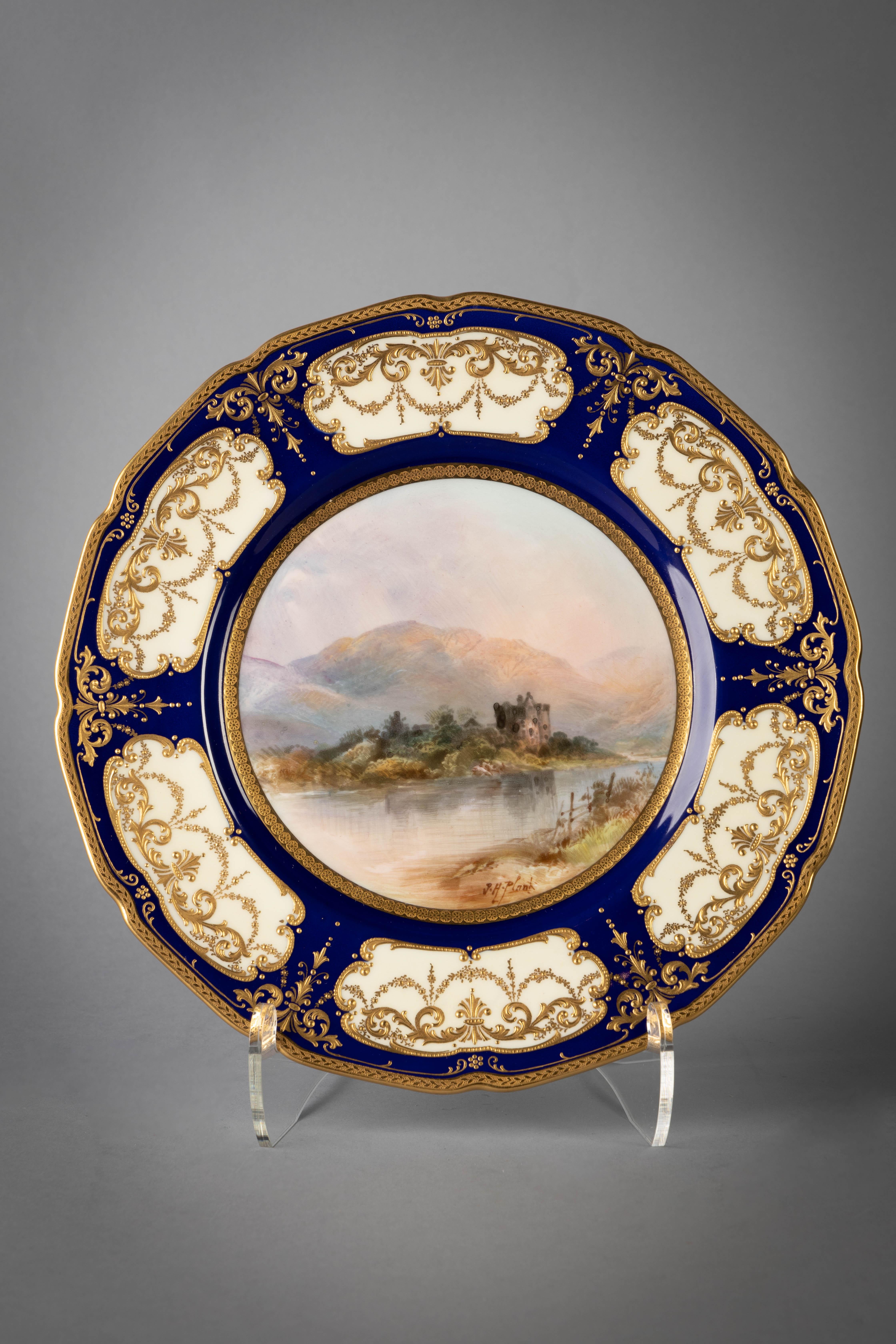Cream ground with a wide cobalt border decorated with raised gold foliage to shaped cartouches revealing the cream body, polychrome enamel decorated centers titled on the reverse. Signed J.H. Plant.