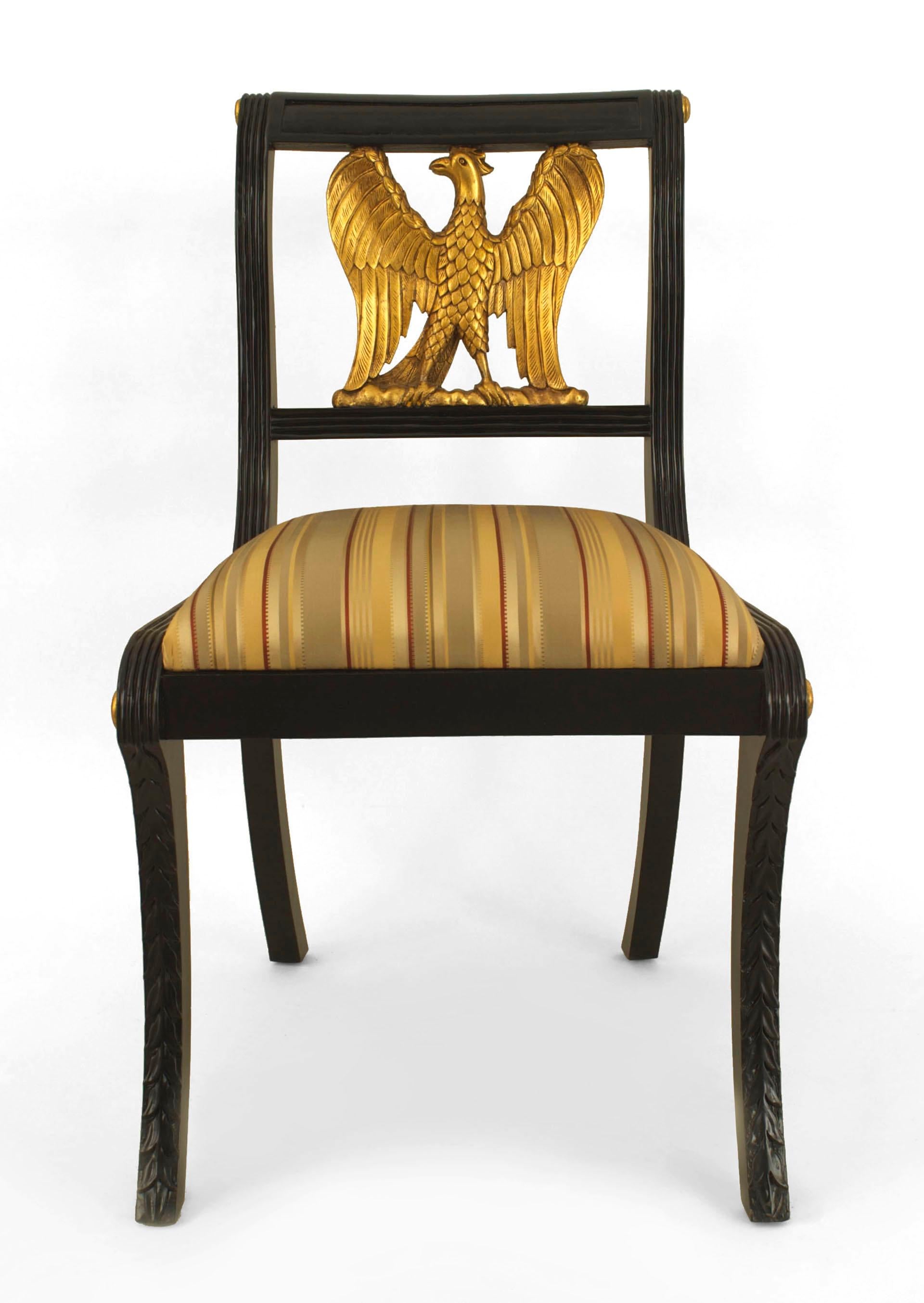 Set of 12 American Federal style (20th Cent) ebonized side chairs with fluted sides and a gilt carved eagle back with an upholstered seat.
