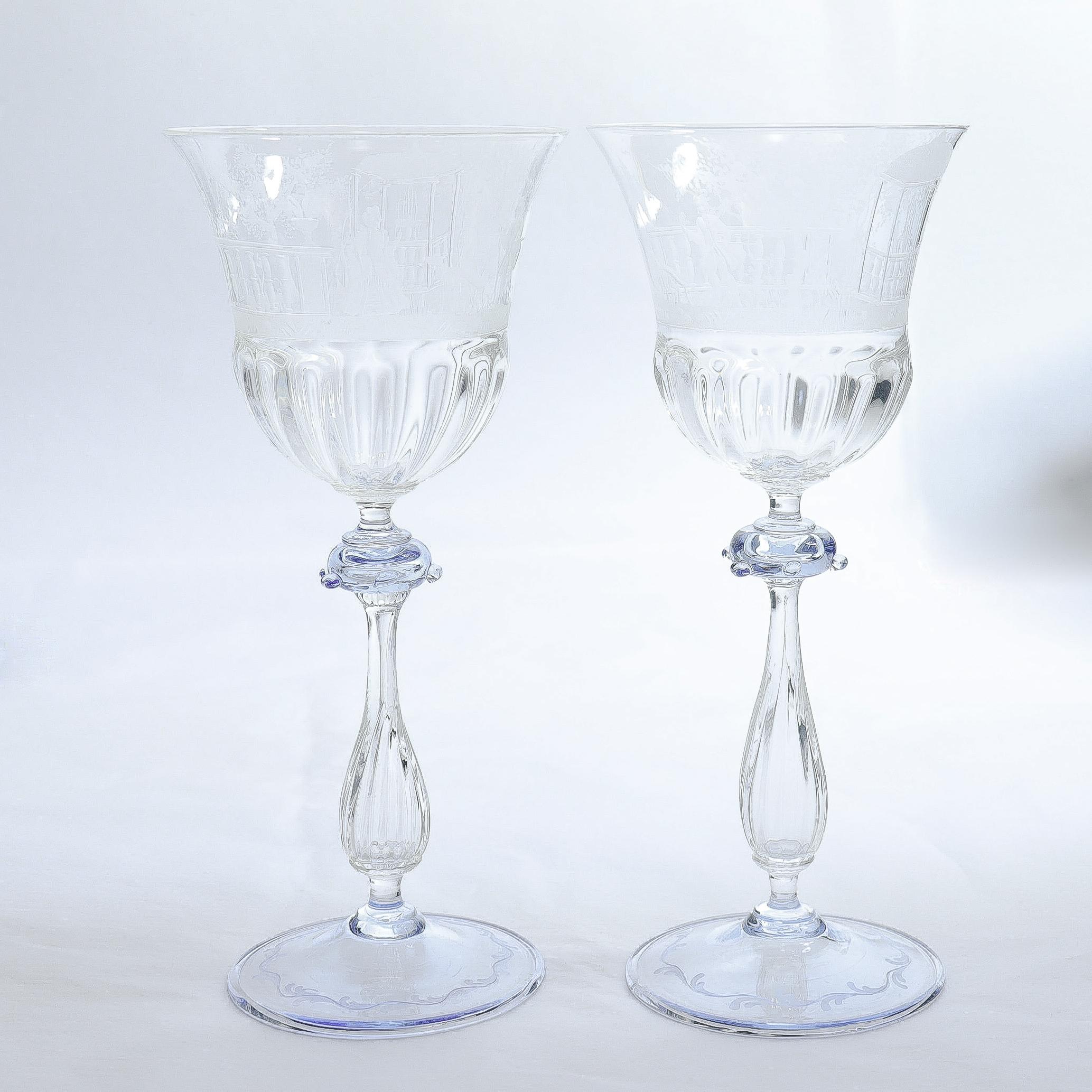 A fine vintage set of 12 Venetian glass wine stems.

Attributed to Salviati.

In clear glass with a light blue suppressed ball knops with small applied prunts, fluted baluser stems, and blue wafer feet. 

Each shaped cup engraved with scenes of