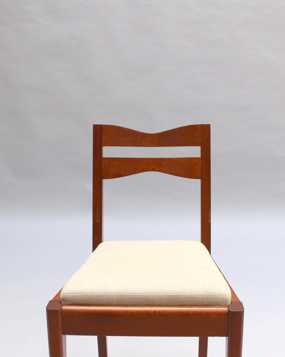 Satz von 12 feinen französischen Art-Déco-Esszimmerstühlen aus Eichenholz von Dudouyt im Angebot 7