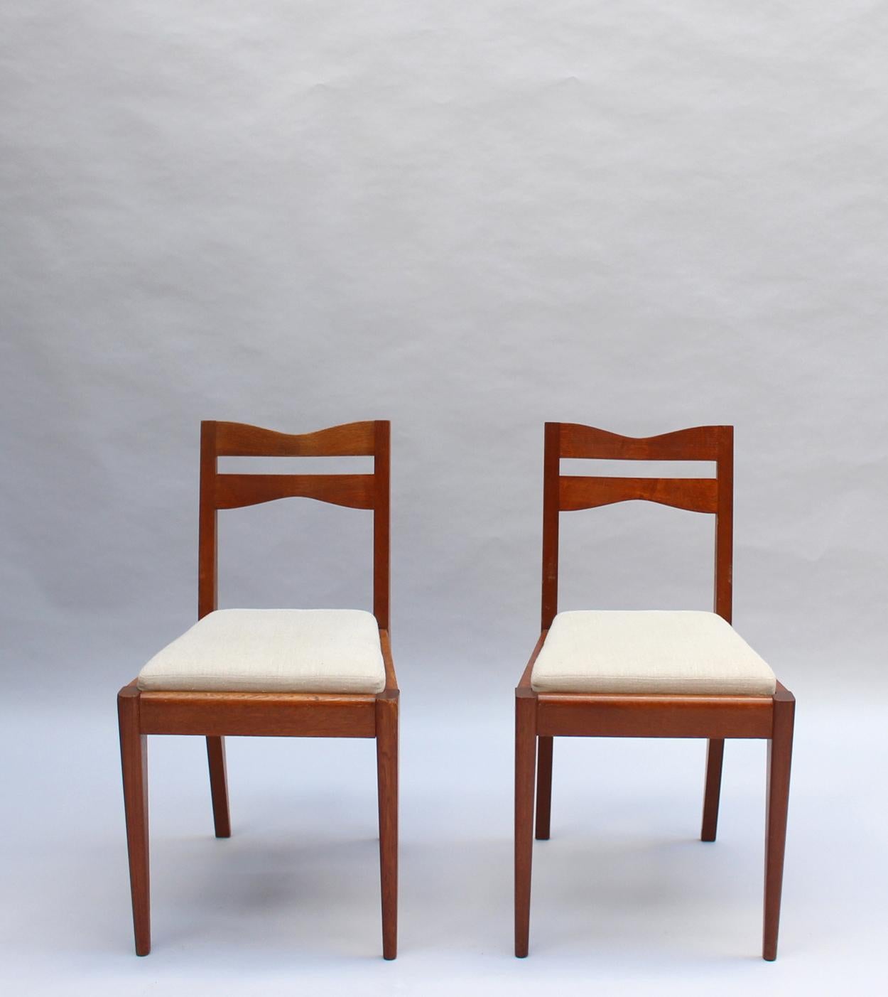 Satz von 12 feinen französischen Art-Déco-Esszimmerstühlen aus Eichenholz von Dudouyt im Angebot 11