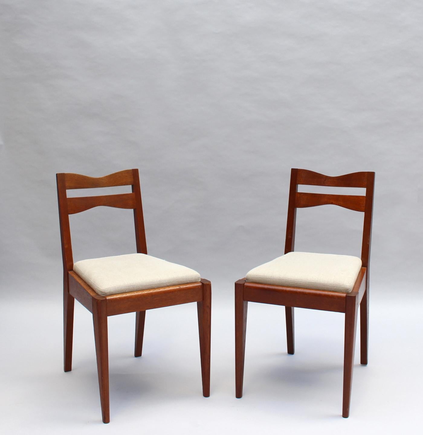 Satz von 12 feinen französischen Art-Déco-Esszimmerstühlen aus Eichenholz von Dudouyt im Angebot 13