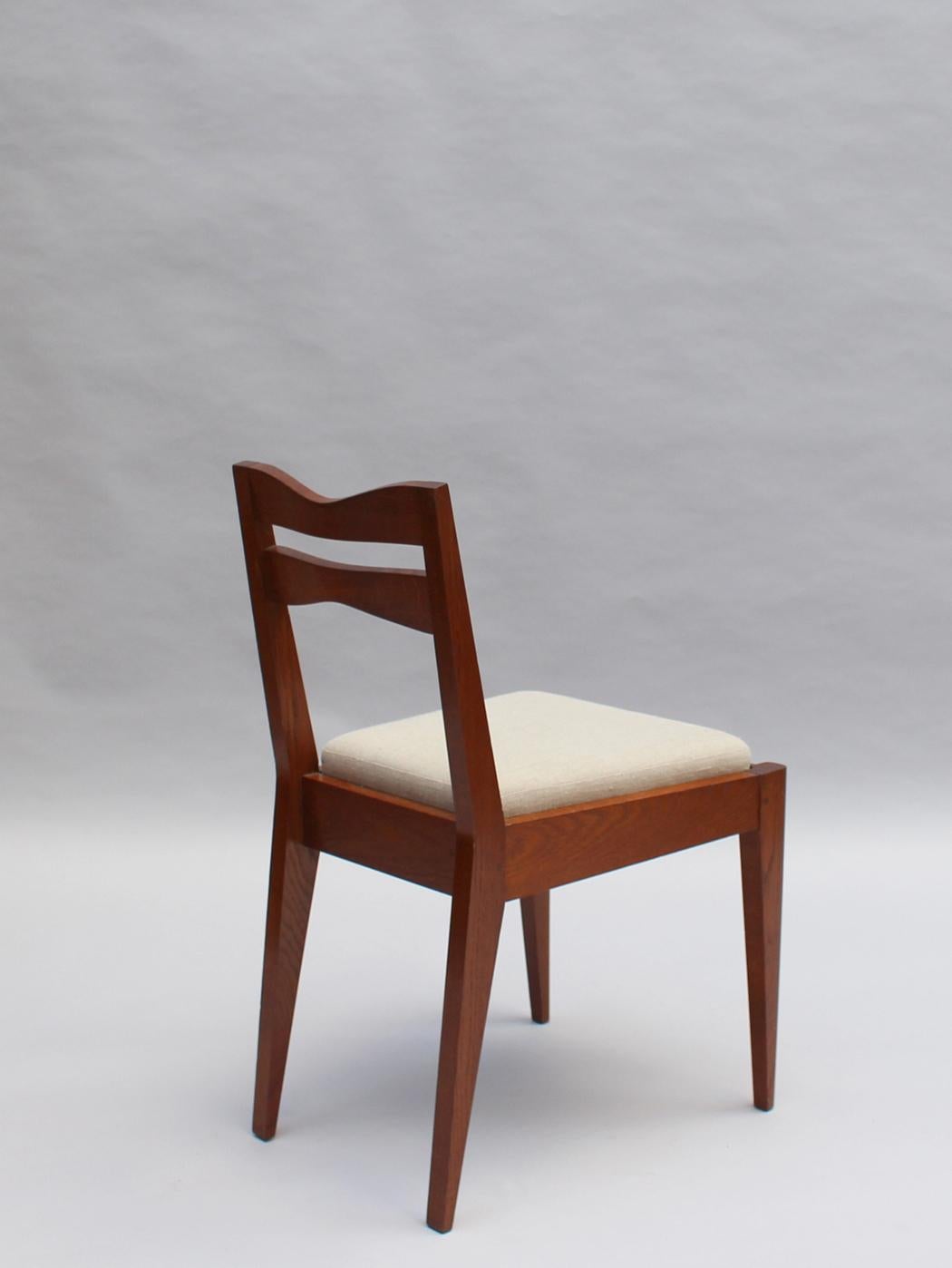 Satz von 12 feinen französischen Art-Déco-Esszimmerstühlen aus Eichenholz von Dudouyt (Mitte des 20. Jahrhunderts) im Angebot