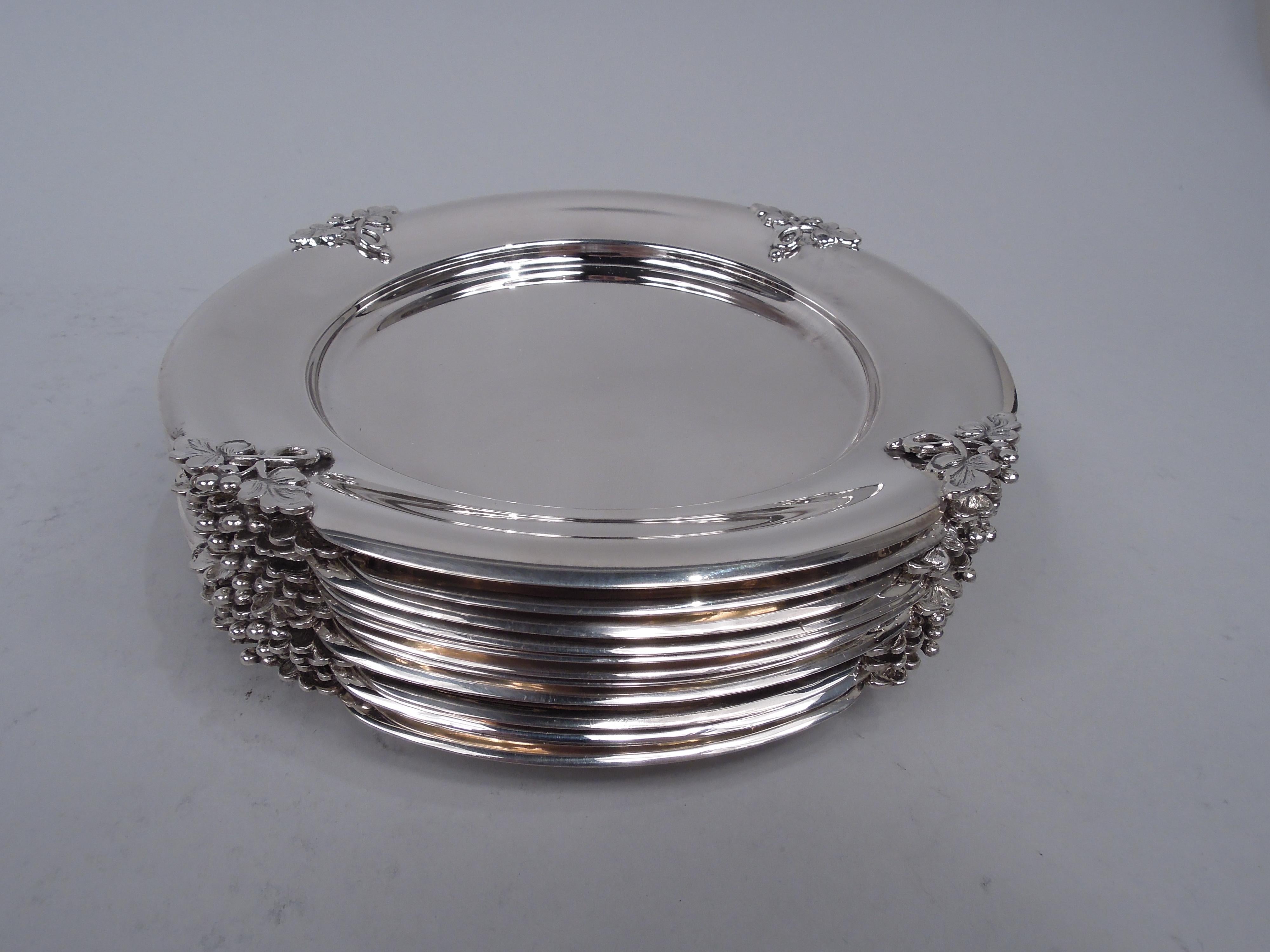 Alexandria sterling silver bread and butter plates. Made by Fisher Silversmiths in Jersey City, New Jersey. Each: Round well and concave shoulder interspersed with 4 open leafing tendrils mounted to cutout triangles. Fully marked including maker’s