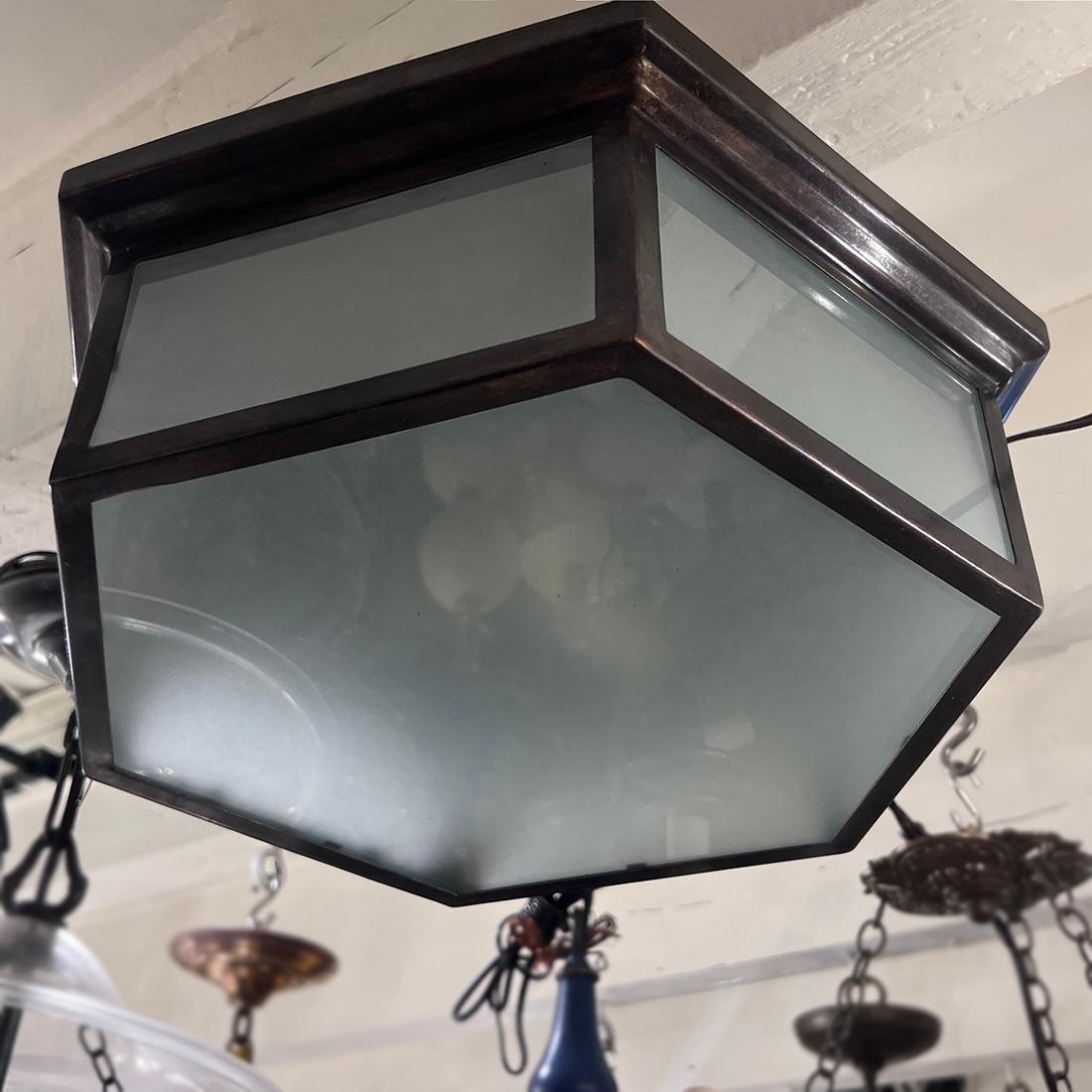 A set of 12 circa 1950s Italian patinated brass light fixtures with inset frosted glass and 3 candelabra interior lights. Sold individually.
Measurements:
Height: 5
