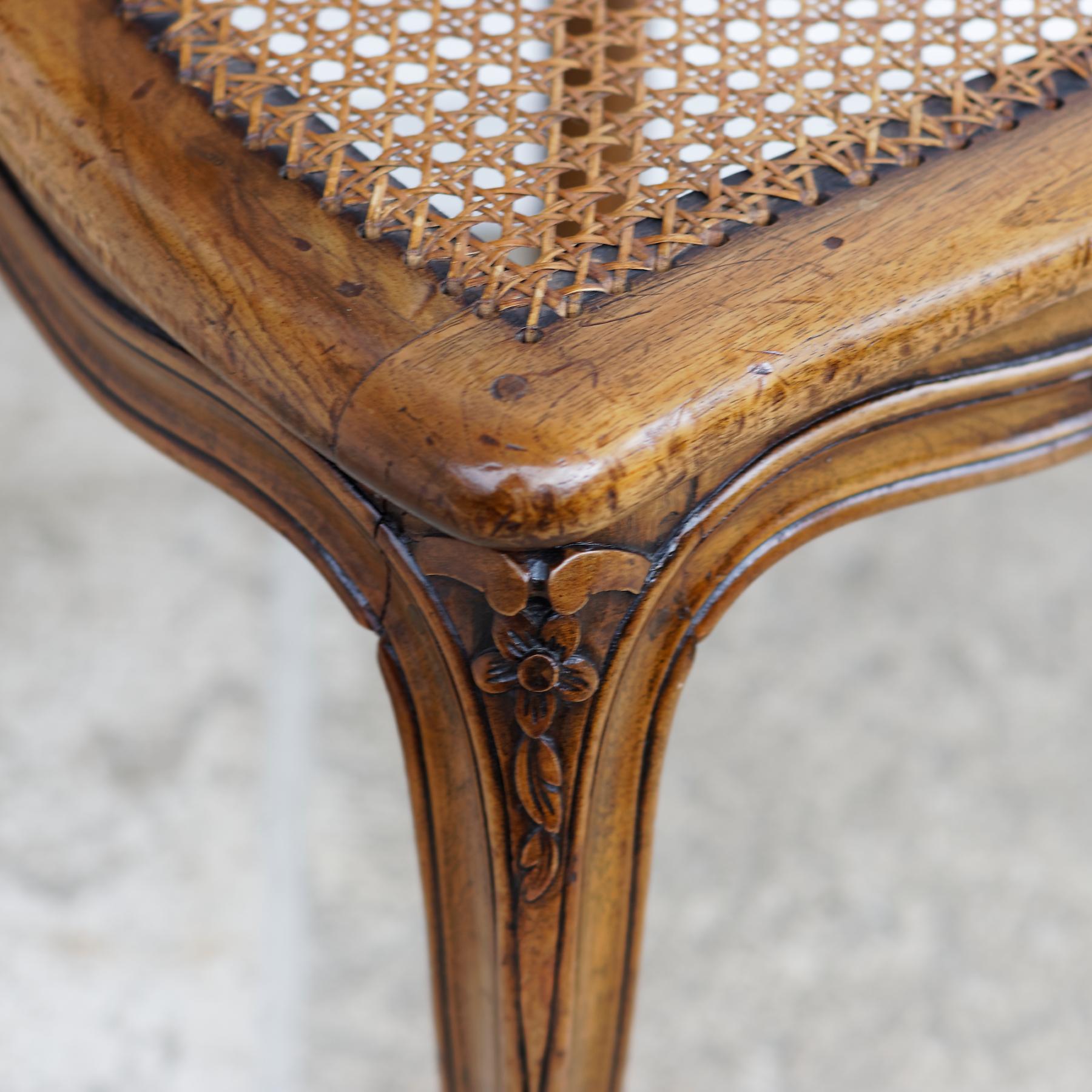 A beautiful set of twelve Belle Époque caned dining chairs, France, late 19th century. The chairs are of Louis XV style and the model is a so called 