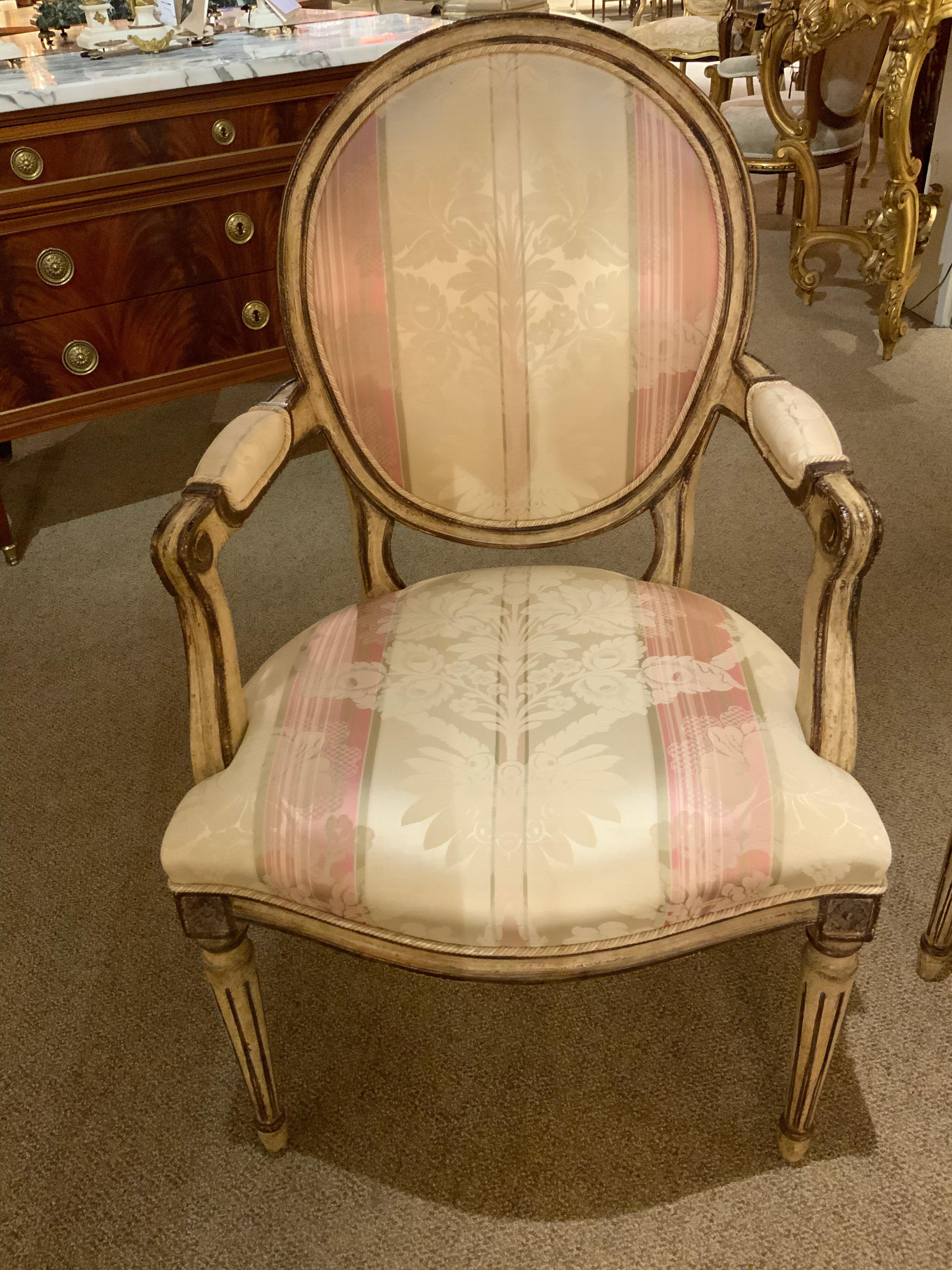 Set of twelve Louis XVI style oval back dining chairs with a reeded leg. All of the chairs are sturdy
And tight without structural problems. They are faux painted in a cream color and rimmed in a
Deep bronze hue. Great set of 12! The set consists