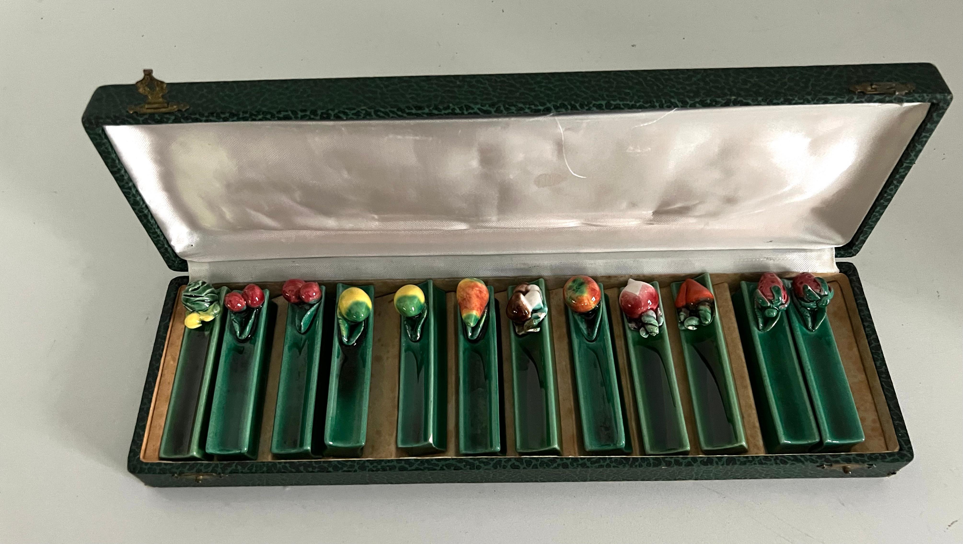 A wonderful set of Majolica knife rests acquired in Paris France. The set is in original box and contains lemons, cherries, mushrooms, turnips, strawberries, tomato, cabbage and pear. extremely nice and a very chic look for any setting especially