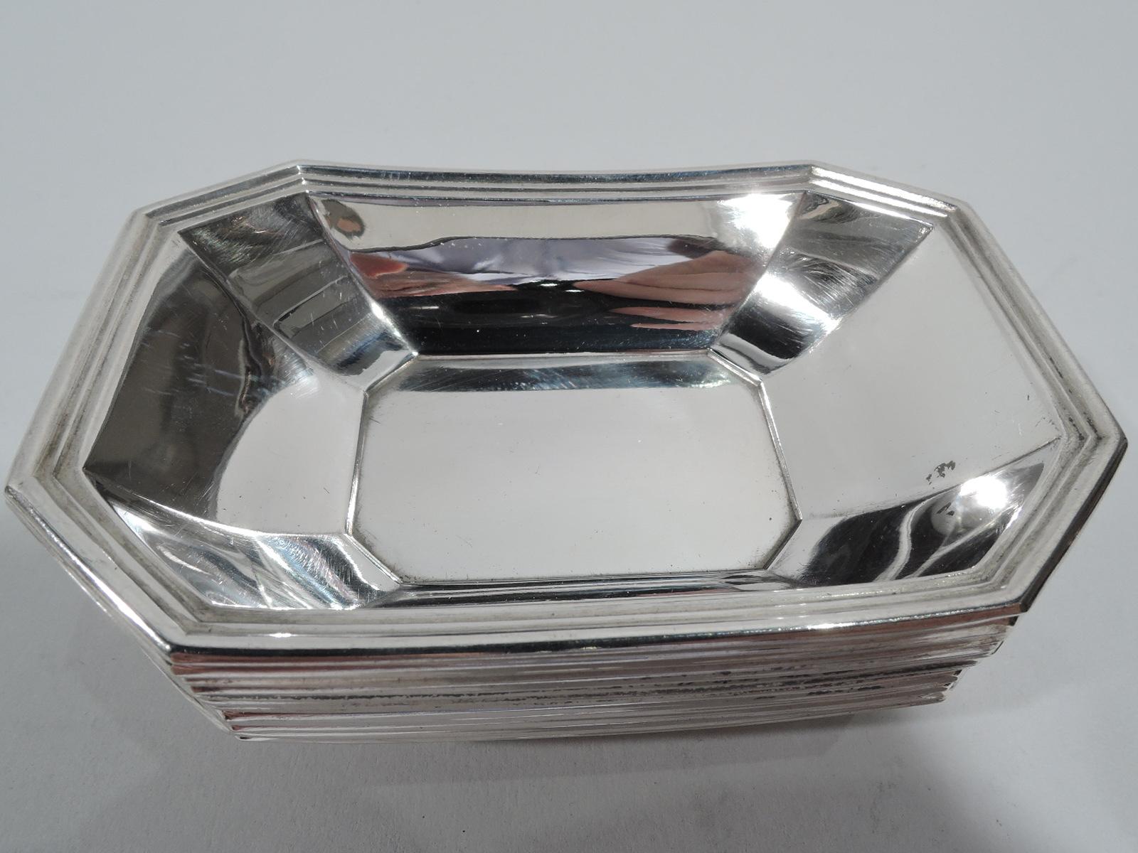 Set of 12 Fairfax sterling silver nut dishes. Made by Gorham and Durgin (part of Gorham) in Providence. Each: Rectilinear with curved and tapering sides, concave corners, and reeded rim. Great pieces in the historic Art Deco pattern. Fully marked