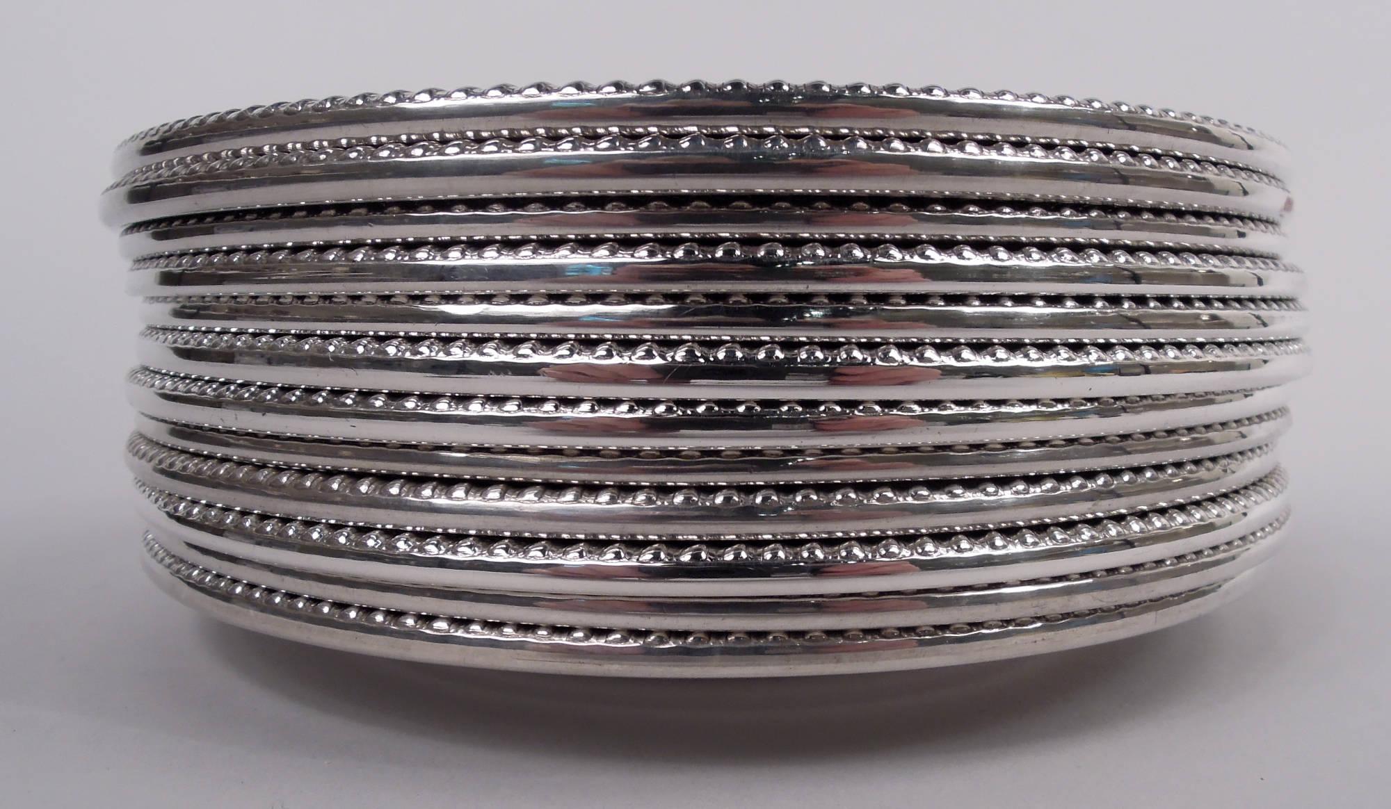 Set of 12 Kensington sterling silver bread and butter plates. Made by Gorham in Providence. Each: Round with deep well and Georgian-style gadrooned rim. Interlaced script monogram engraved on shoulder. Fully marked including maker’s stamp and no.