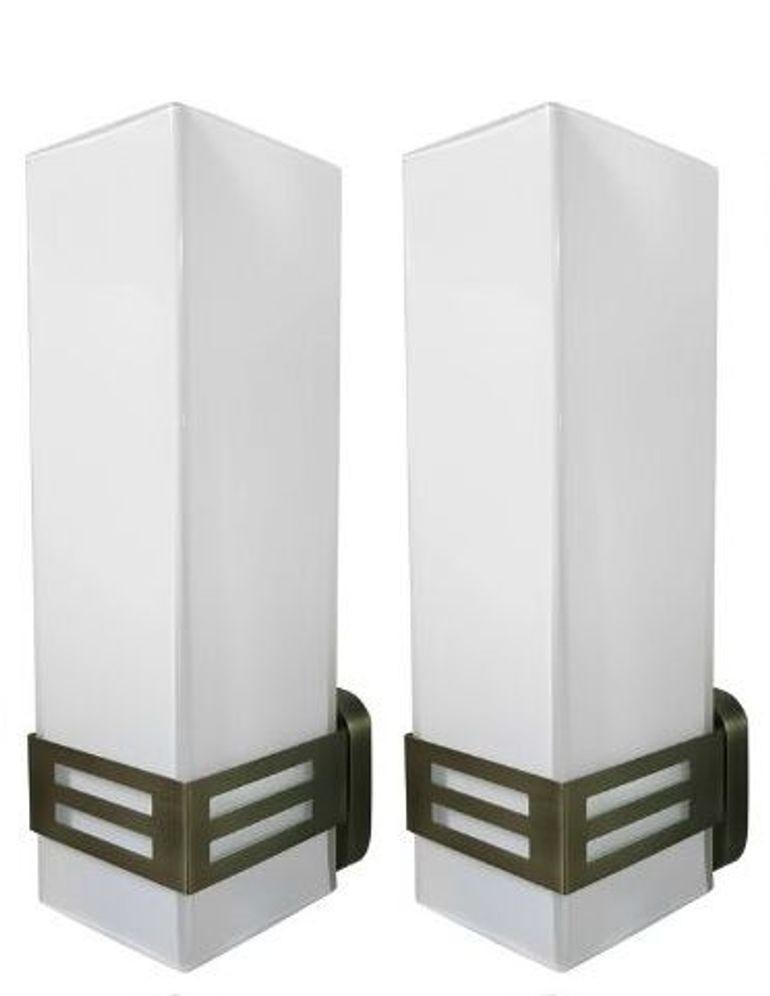 Elegant and architectural, this set of twelve limited-edition Grattacielo sconces features rectangular frosted Murano glass panels mounted on minimalist bronzed metal frames. Each sconce embodies refined Italian craftsmanship, casting a soft and