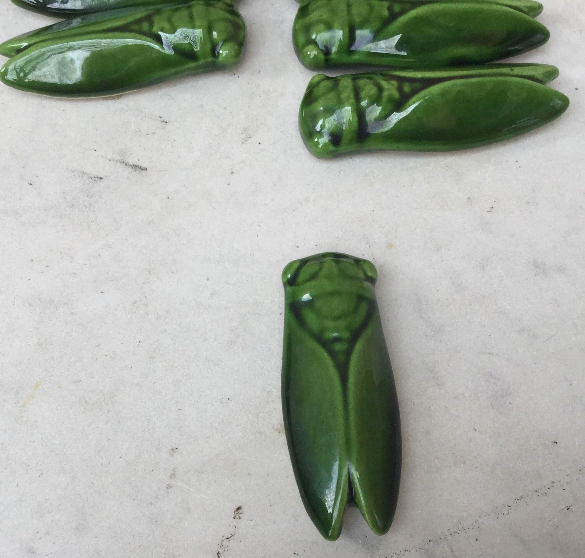 Set of 12 green majolica cicada knife rests from South of France (Provence).