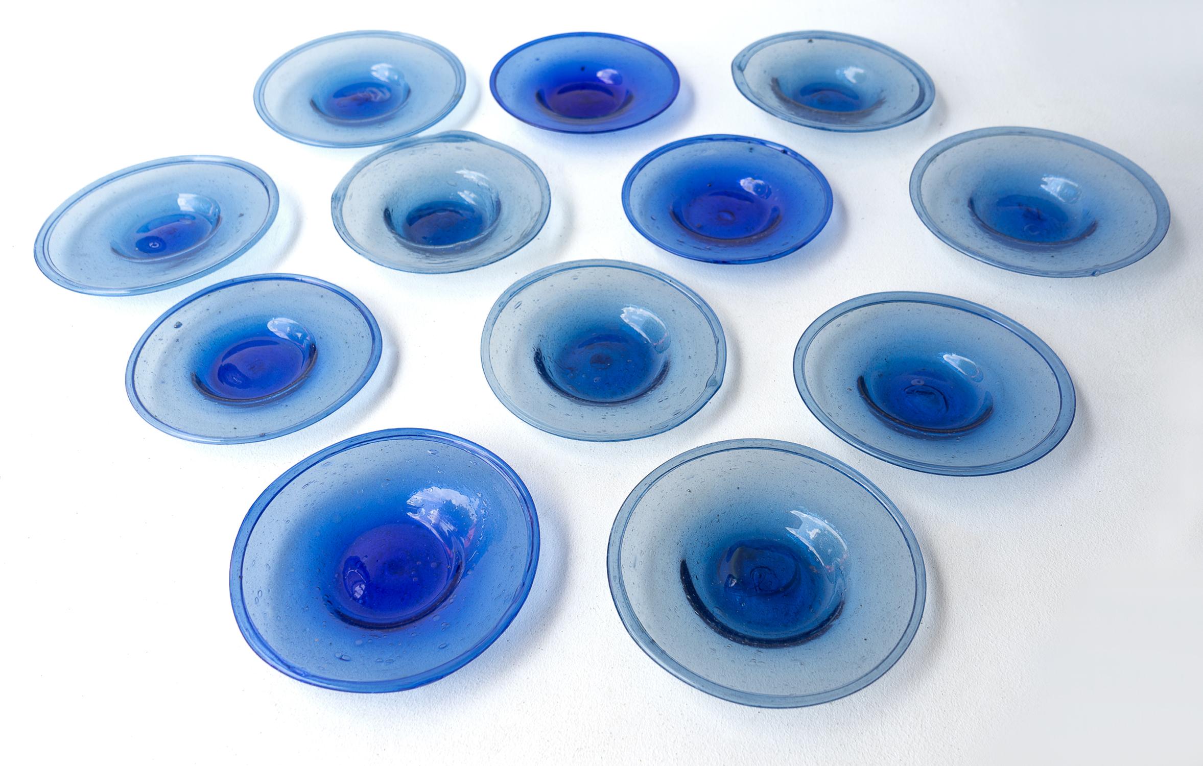SET OF GLASS DISHES

Each is individually hand blown and unique, slightly varying in colour shape and thickness.

Rich cobalt blue colour with bubble inclusions.

Rough pontil mark underneath.

Unsigned but in the manner of Biot.

They are in great