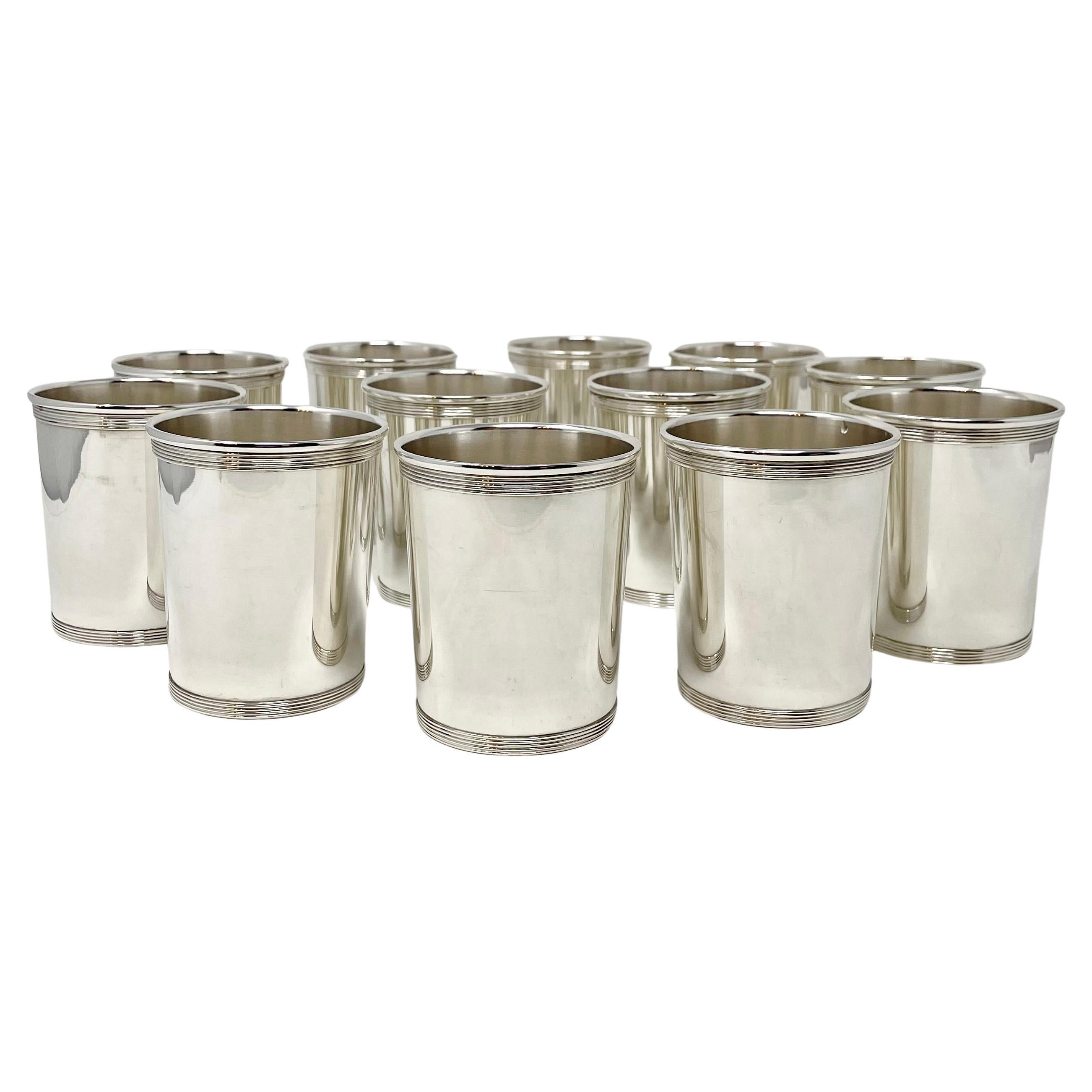 Set of 12 hand-made American sterling silver mint julep cups with banded design.