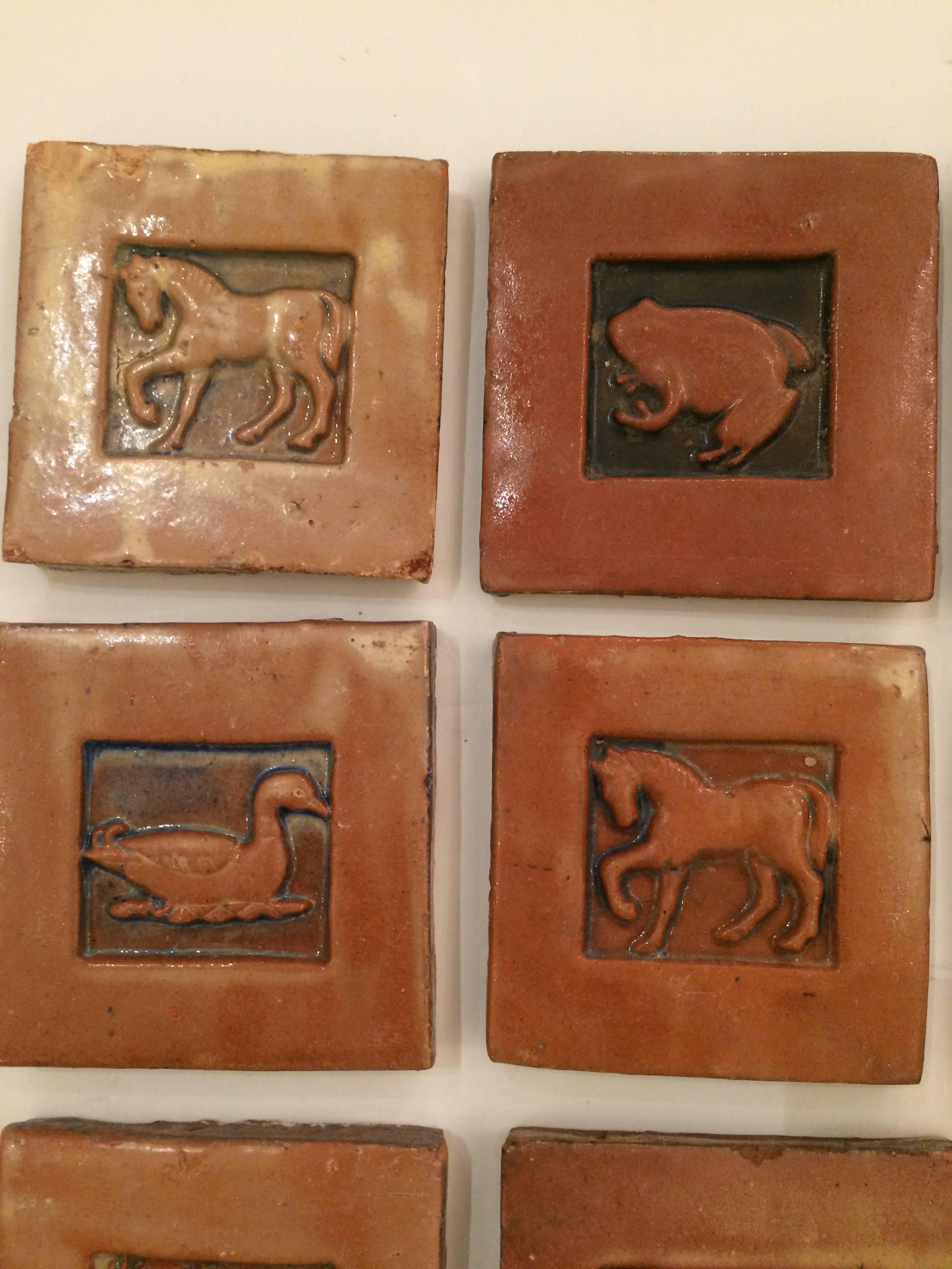 Beautiful handmade terracotta tiles with charming animals depicted in the centres, created at Moravian tile works in Bucks County about 20 years ago.