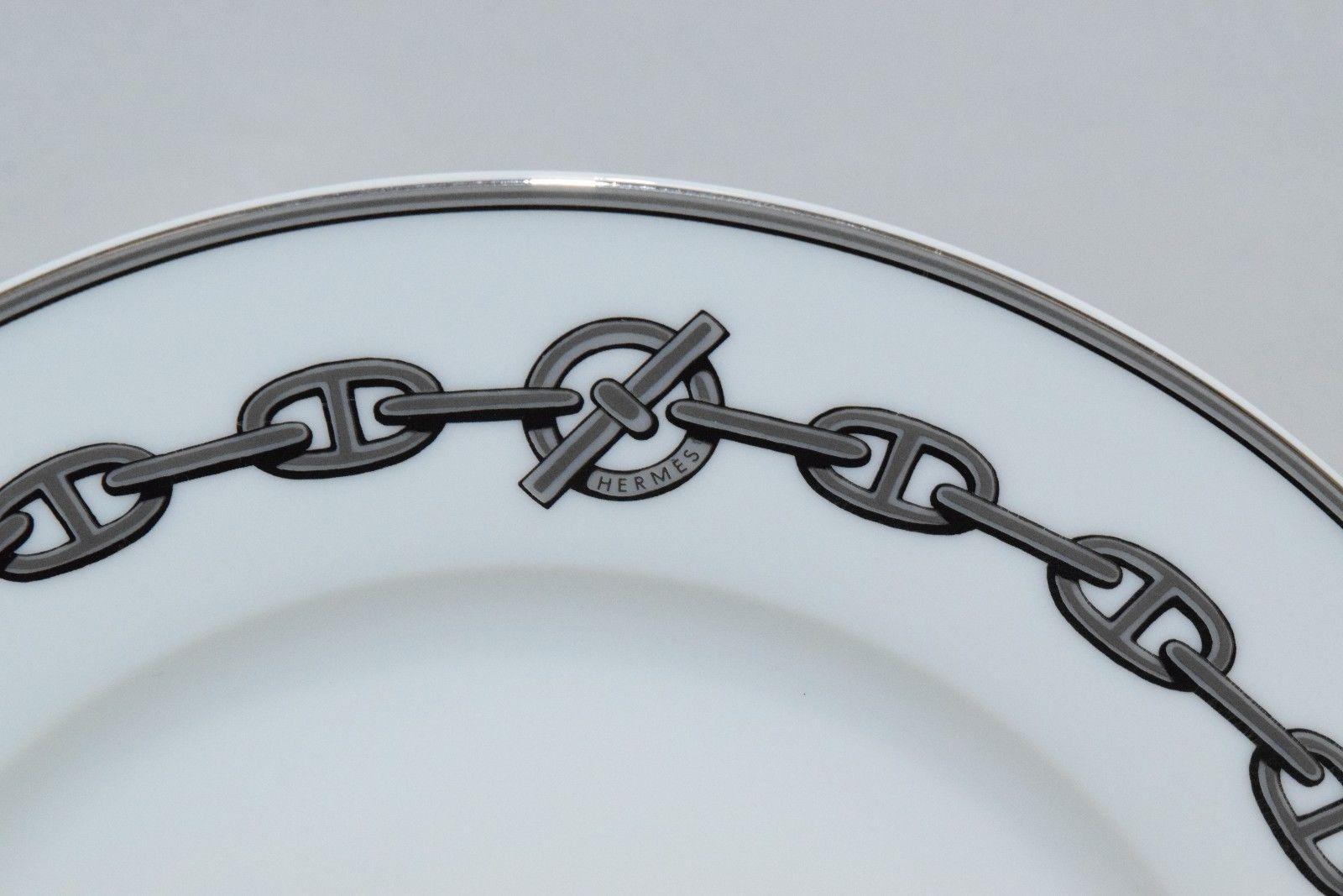 A set of 12 (twelve) place settings in the Chaine D'Ancre pattern in gray by Hermes. Porcelain. Signed. Made in France, produced from 1997-2017.

One of Hermès most coveted patterns. Featuring the signature chain link border against pristine