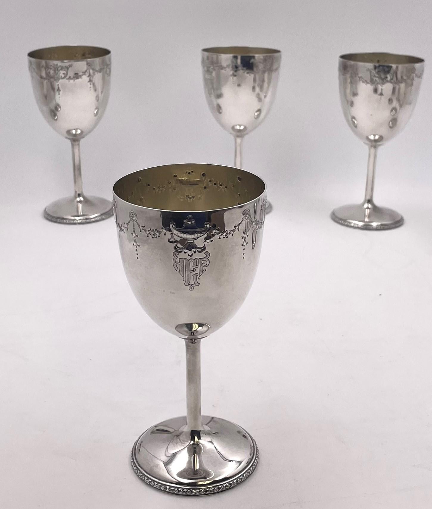 Set of 12 Barbour for International Sterling, sterling silver goblets, adorned with garland-like motifs showcasing urns and stylized natural motifs, from the early 20th century, on a matching tray. The goblets measure 6 1/4'' in height by 3'' in