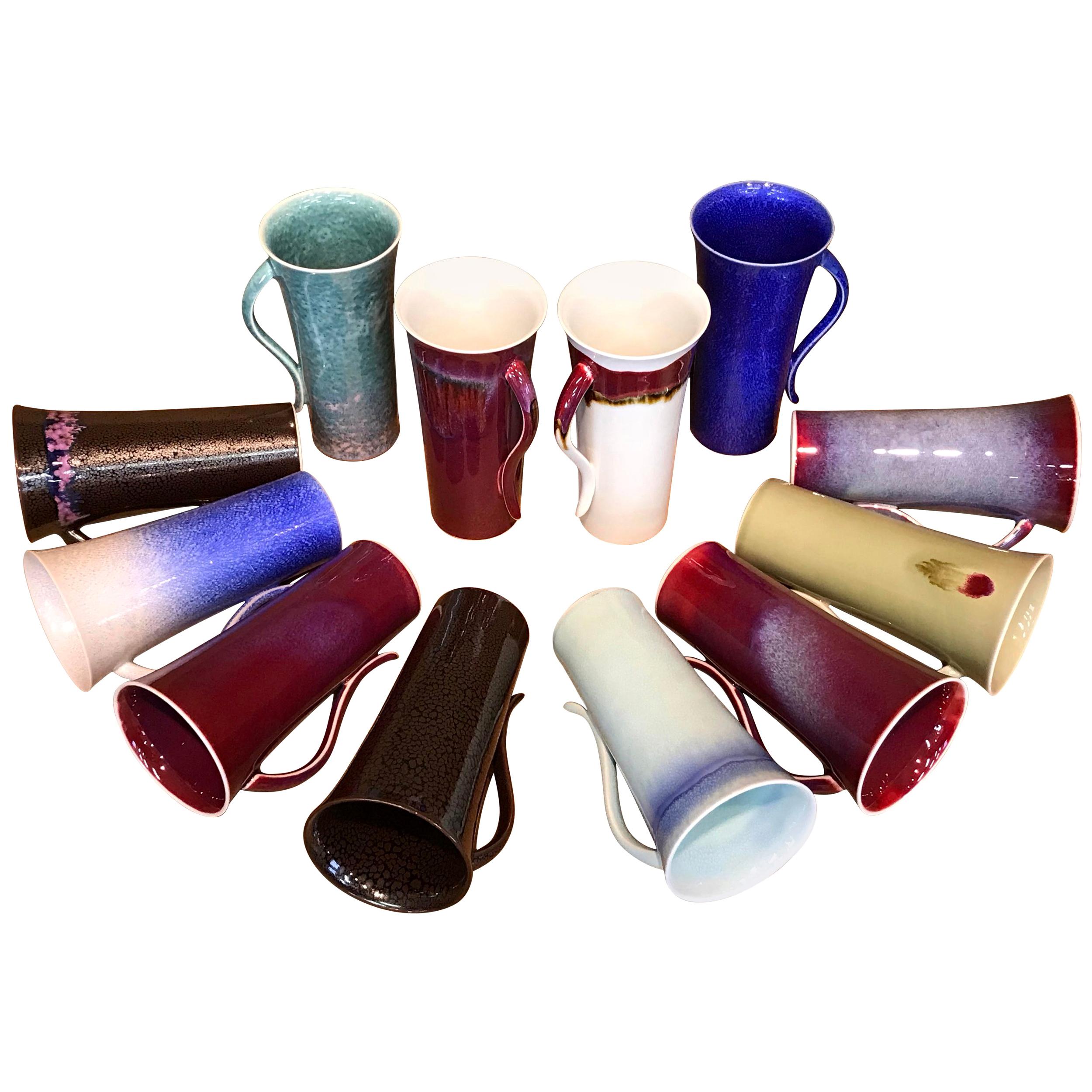 Striking extraordinary set of 12 Japanese contemporary tall hand-glazed porcelain mugs in a beautiful shape masterfully glazed in the artist's breathtaking signature colors like wine-red, green and white, signed pieces by widely respected
