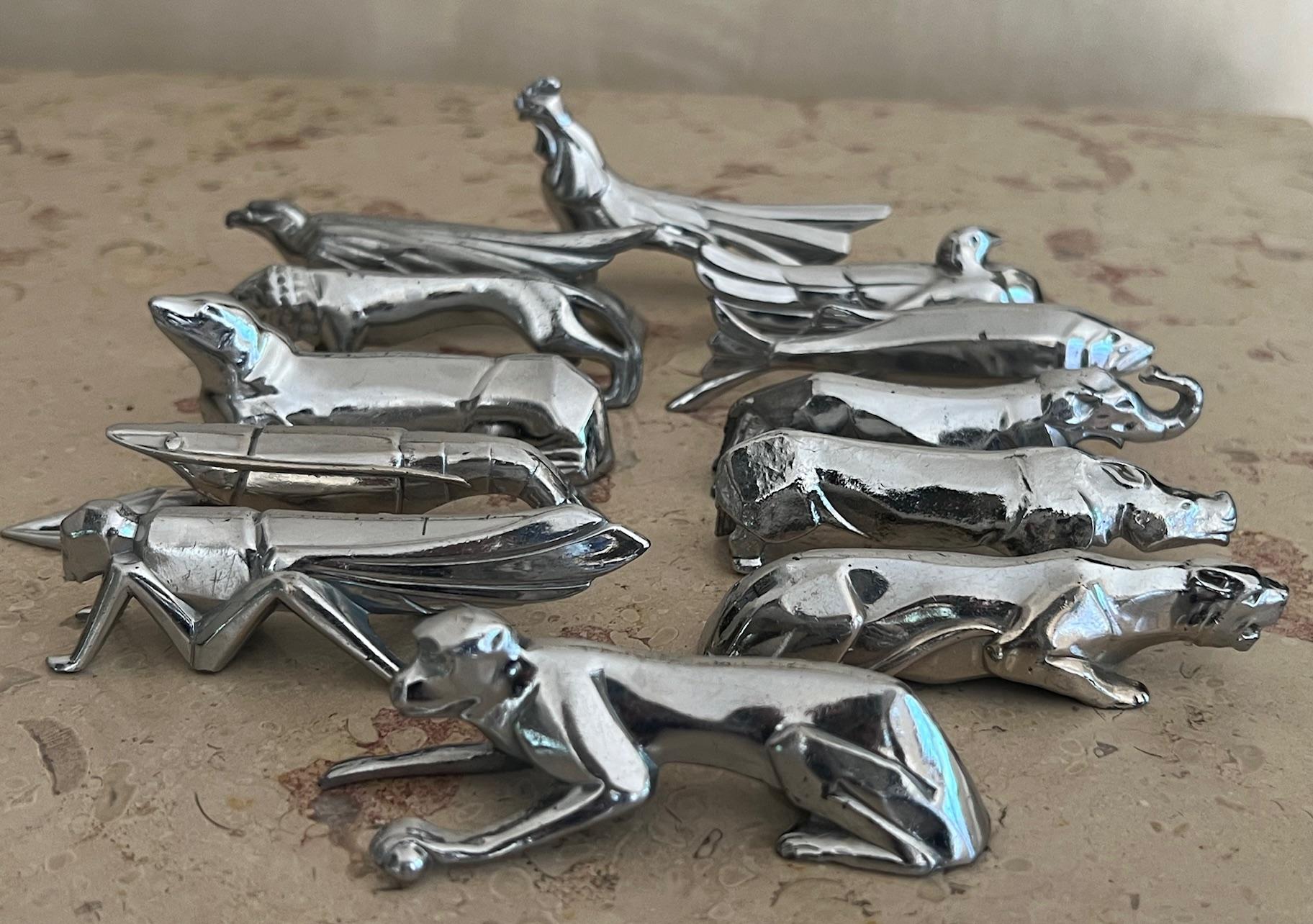 Made in mid 20th century in France to replicate the style of designer Edouard Sandoz for Christofle. Each piece is made of a cast iron with a plated chrome. The set which is made of a cast iron which is then chrome plated, includes a rooster,