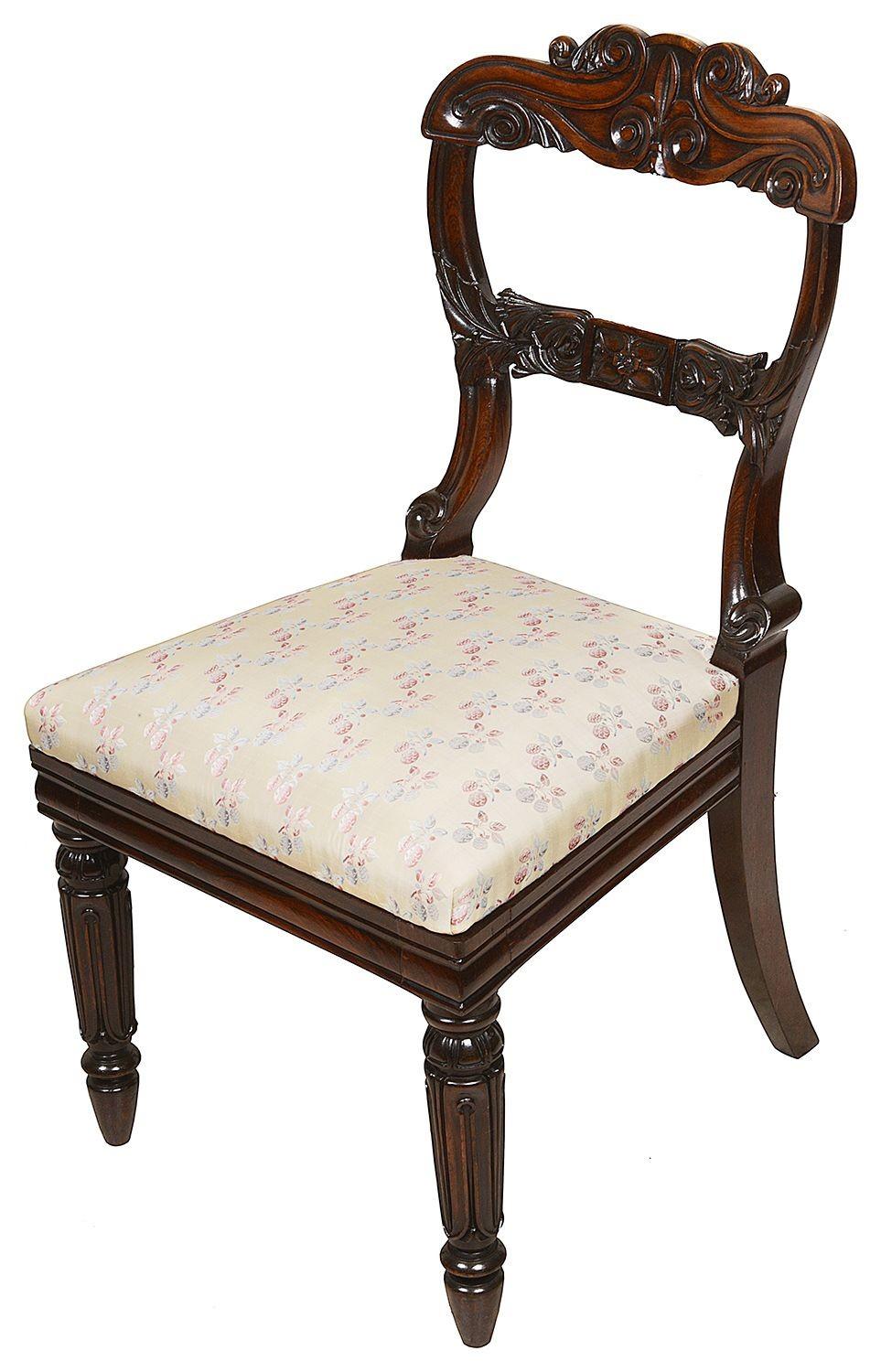 A very good quality set of 12 late Regency period dining chairs, each with wonderful classical carved scrolling decoration to the back rests, upholstered seats, raised on turned tapering reeded legs, circa 1830.
 
Batch 67 60390 NCHKEZ.