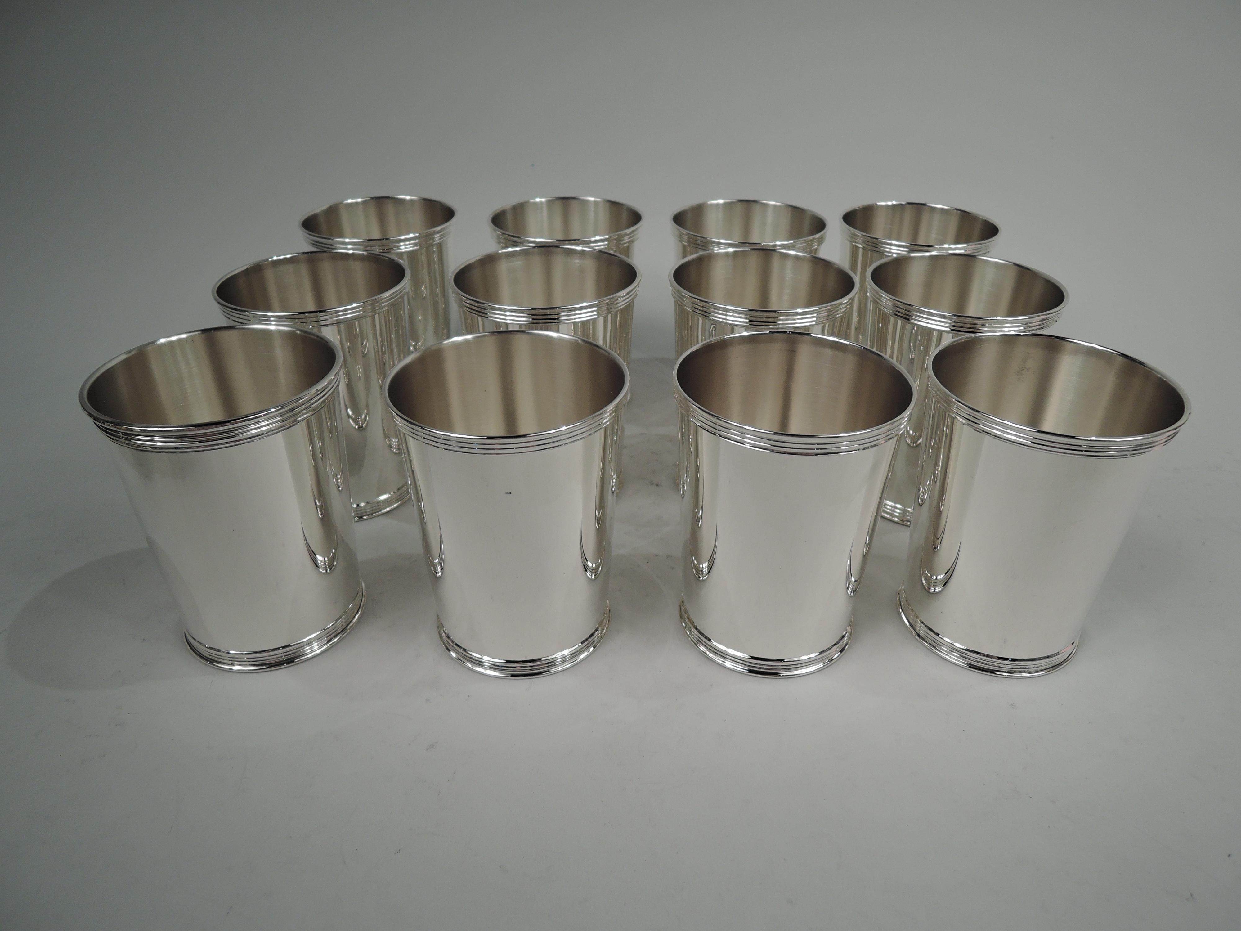 Twelve traditional sterling silver mint juleps. Made by Manchester in Providence. Each: Straight and tapering sides and reeded rim and foot. A big set guaranteed to give your next part lots of go. Fully marked including maker’s stamp and no. 3759.