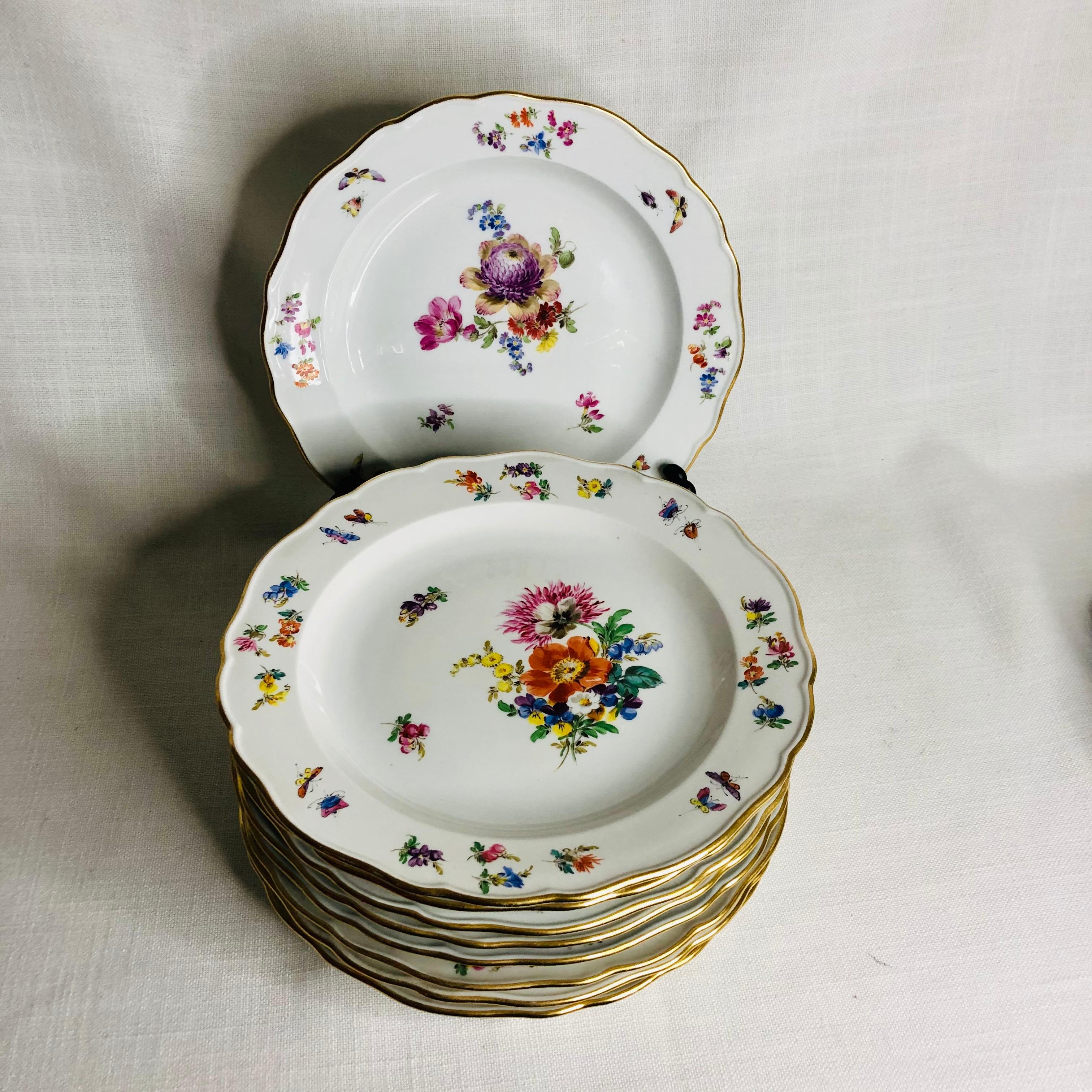 This is a fabulous set of twelve Meissen luncheon or dessert plates. Each of these Meissen plates are beautifully painted with a different large central flower bouquet. The artwork on these plates is exceptional. Inside the gold border, you. can see