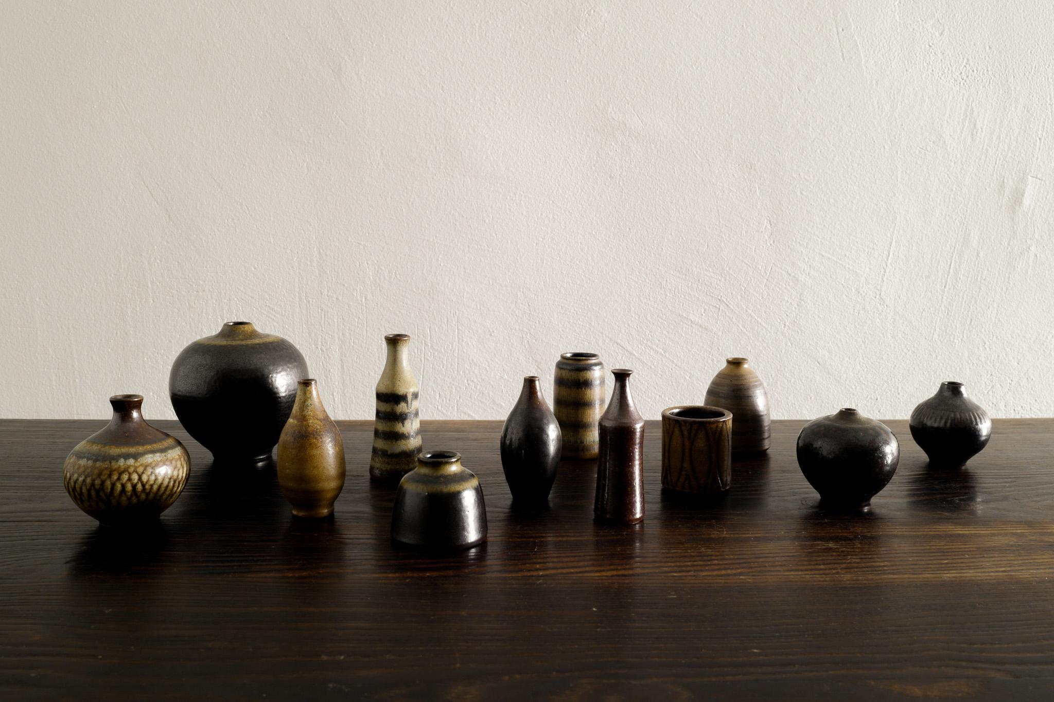 Rare set of 12 mid century miniature vases in glazed stoneware most likely designed by Arthur Andersson and produced by Wallåkra, Sweden in the 1940s. 
In great vintage and original condition, all signed. 

Dimensions: H: 4,5-9,5 cm Diameters: