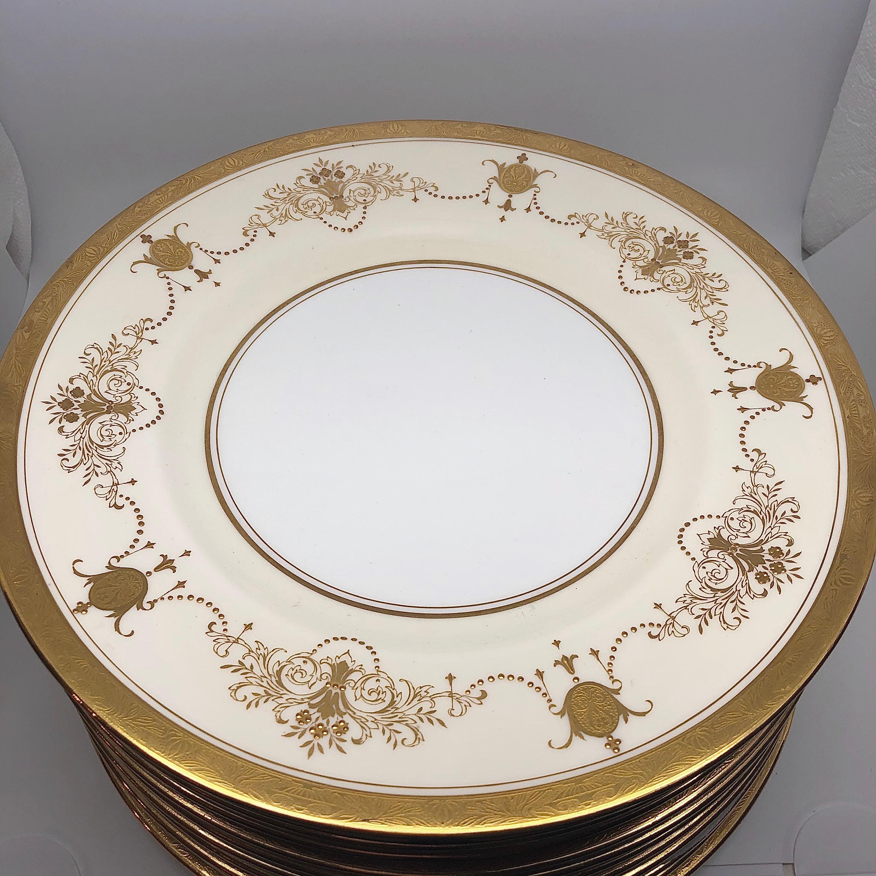 This is a fabulous set of 12 Minton Dinner plates decorated with gilt vases of flowers and ribbons of raised gold jeweling. Minton made them for Davis Collamore in New York in 1911-1920. Davis Collamore was a rival of Tiffany at this time, and sold
