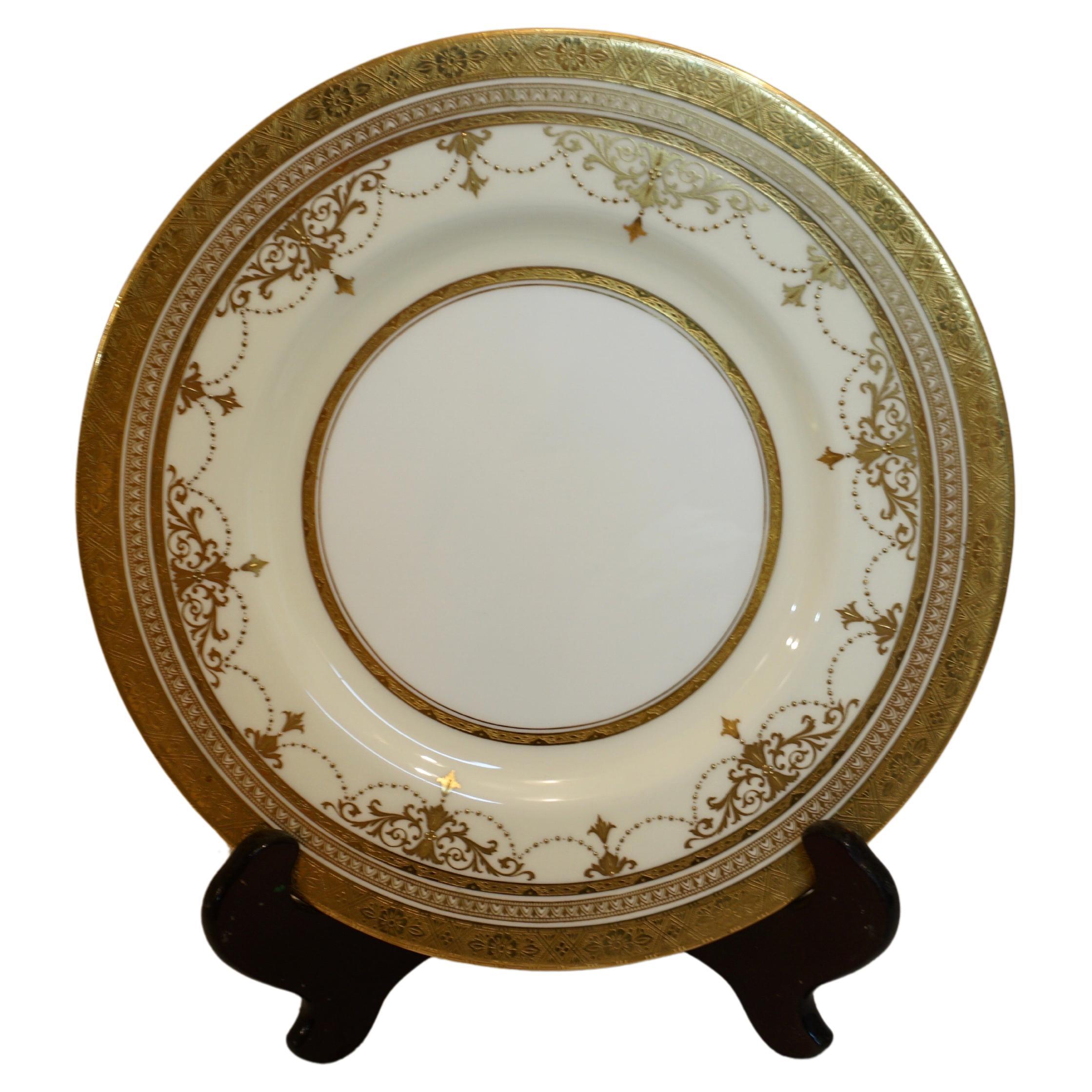 Set of eleven fabulous Minton dinner plates decorated with garlands of raised gold arabesque and raised gold jeweling. They have a gold border with an embossed decoration. They are large, 10.5 inches in diameter. They were made exclusively for