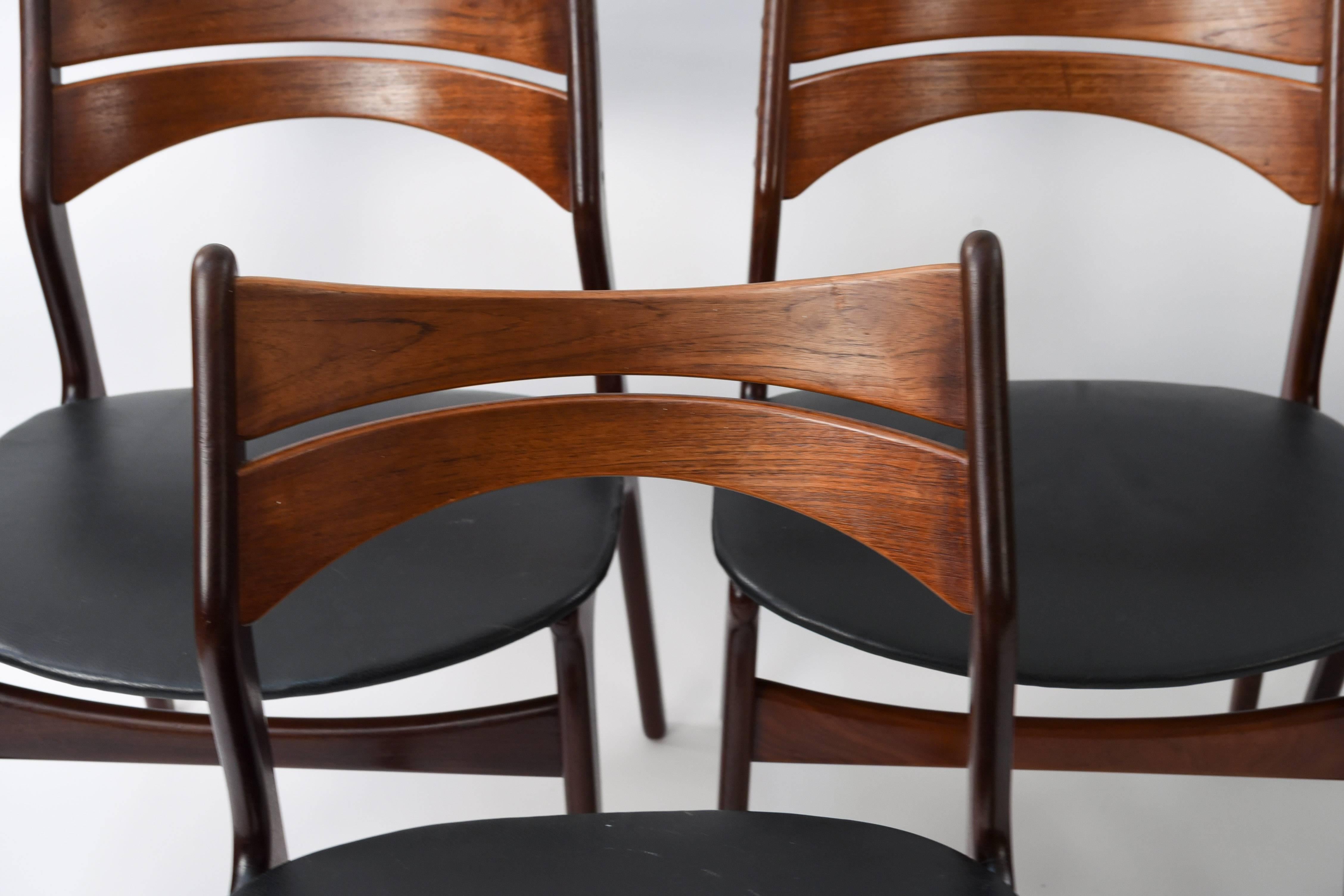 This set of twelve teak dining chairs are model #310 designed by Erik Buch for Christiansen, circa 1950s, Denmark. Very interesting, unique form. Would be a wonderful set for around a dining table. These have been recently reupholstered in