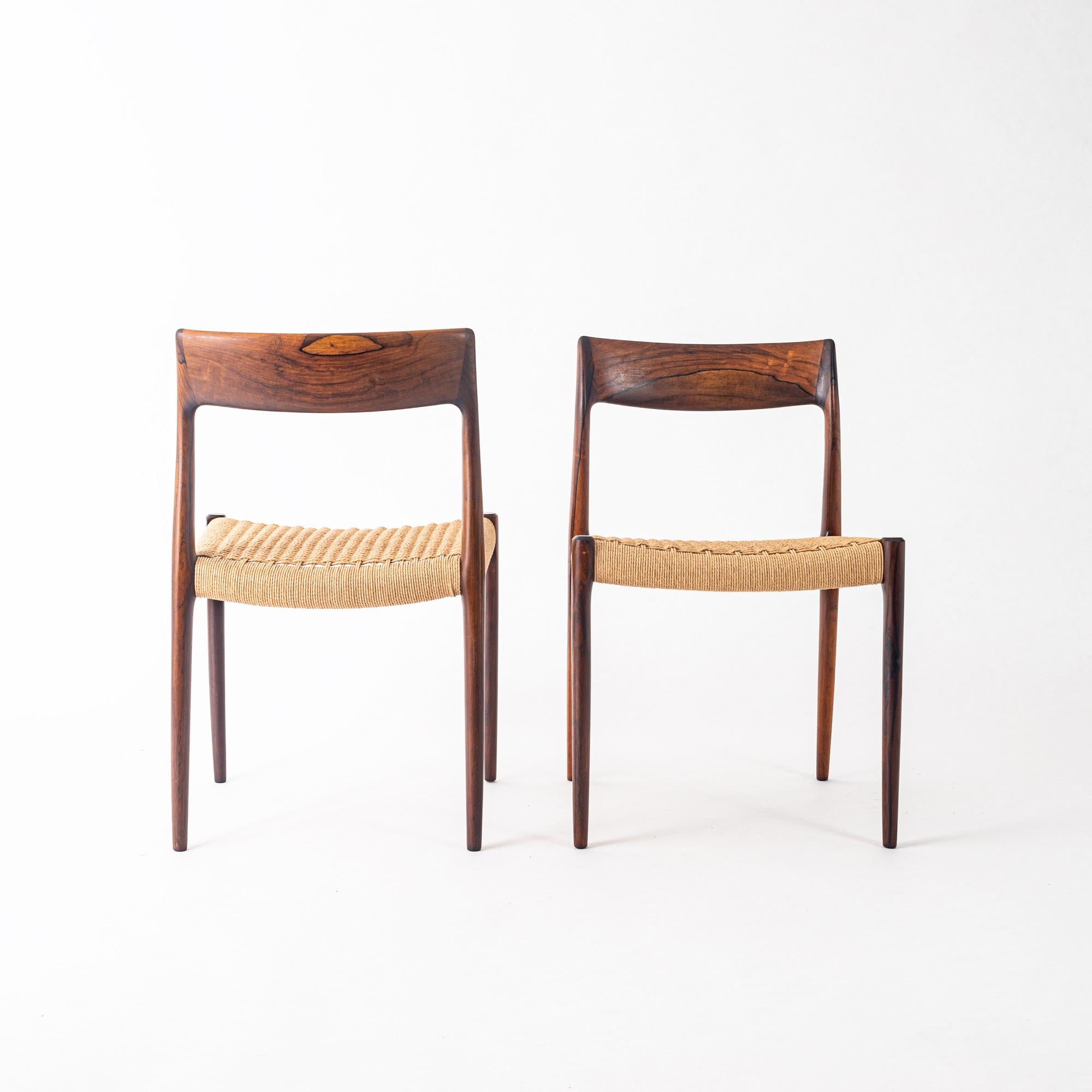 Set of 12 Brazilian rosewood dining chairs designed by Niels O. Moller for J.L. Moller Mobelfabrik, Denmark, 1959. Newly refinished and papercorded seats, the makers mark is on the bottom of each chair. Each chair has unique wood grains, a beautiful