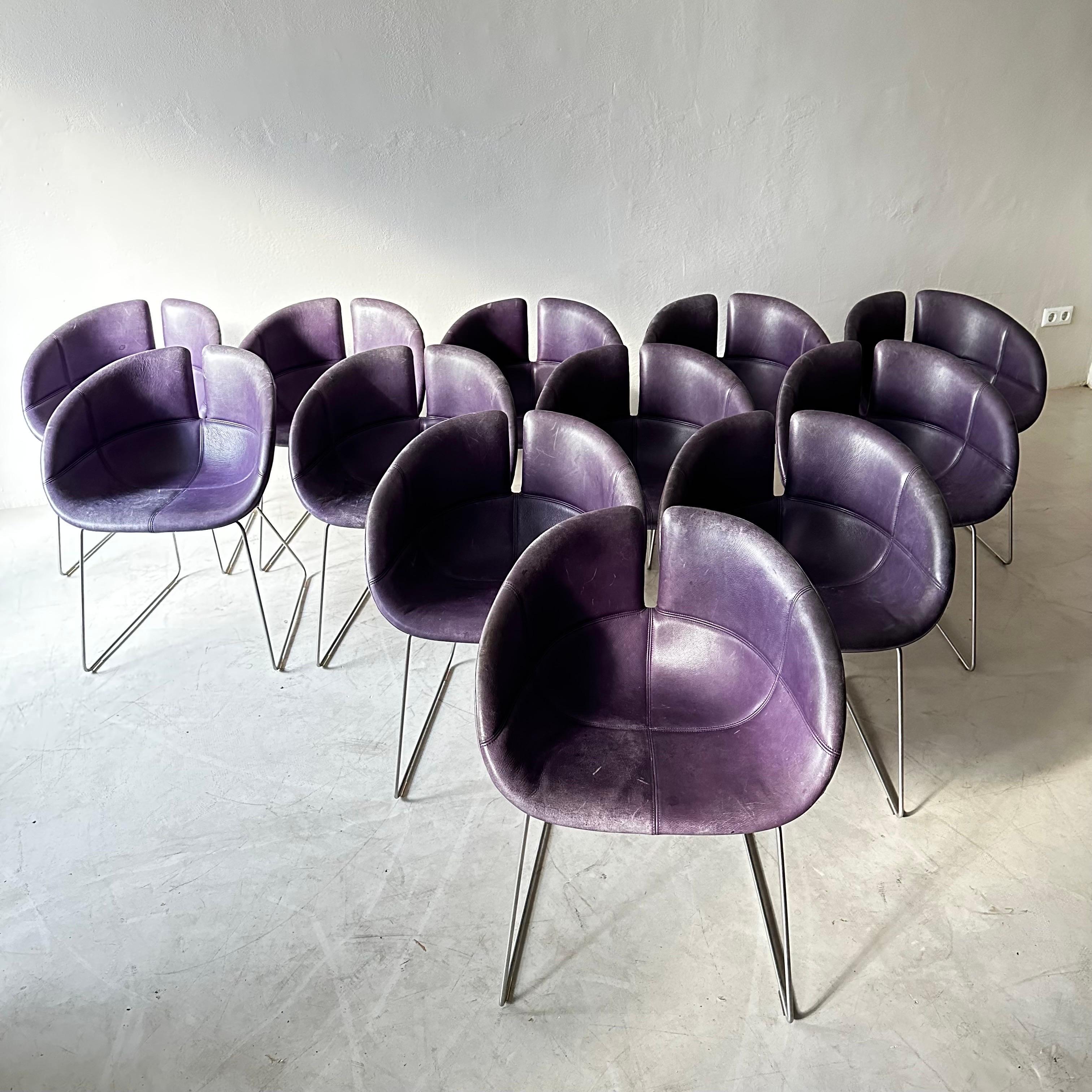 Fjord Dining Arm Chair is designed by Patricia Urquiola for Moroso. Upholstery in original patinated purple leather. Price is for the set of 12 chairs.