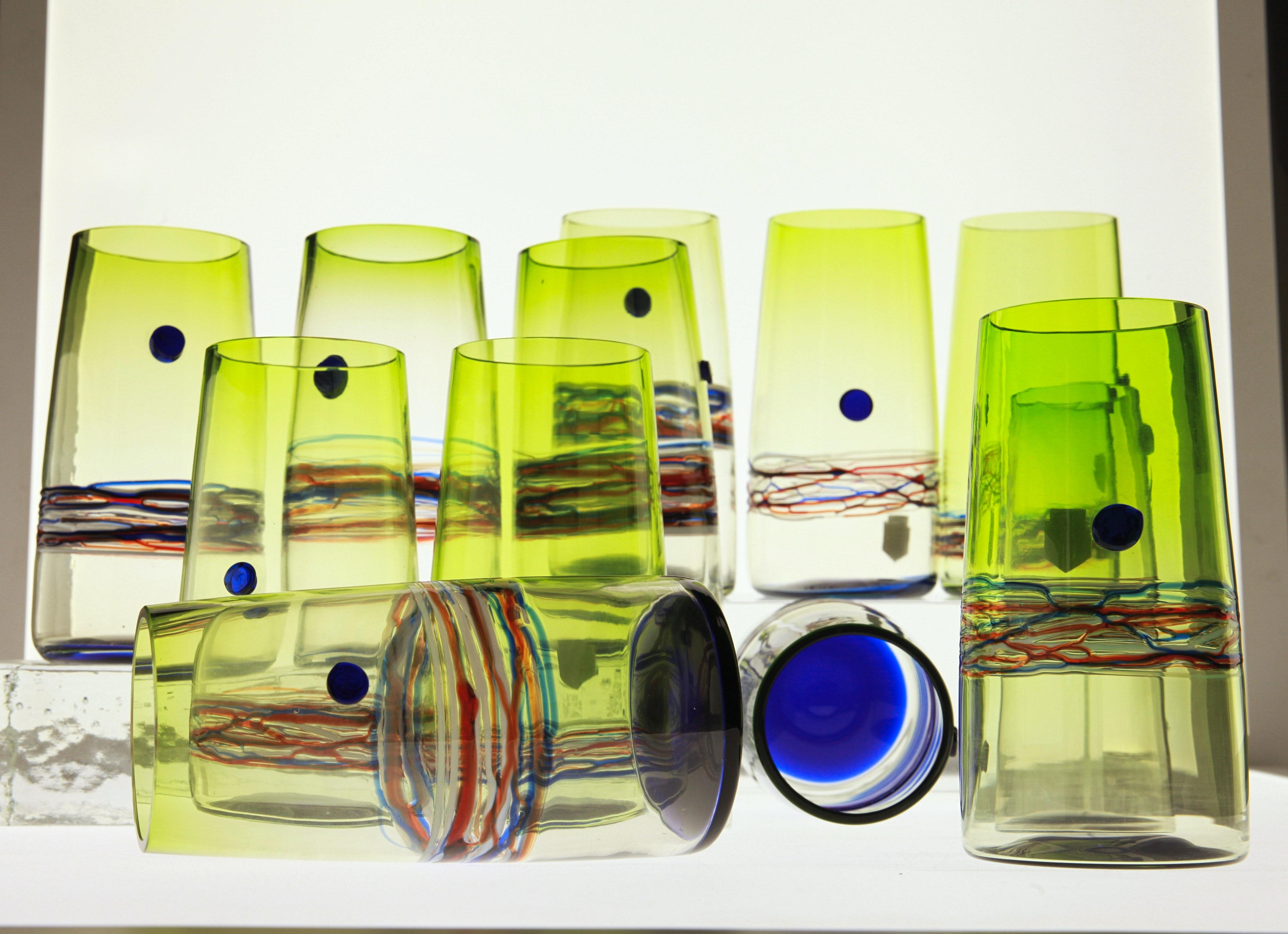 Set of twelve tumblers from Cenedese, made in Murano. Labelled and signed.

For a glass lover and collector. These tall long drink glass have a sfumato technique, striping, a bottom incalmo and a dot. This sum of techniques creates a vibrant and