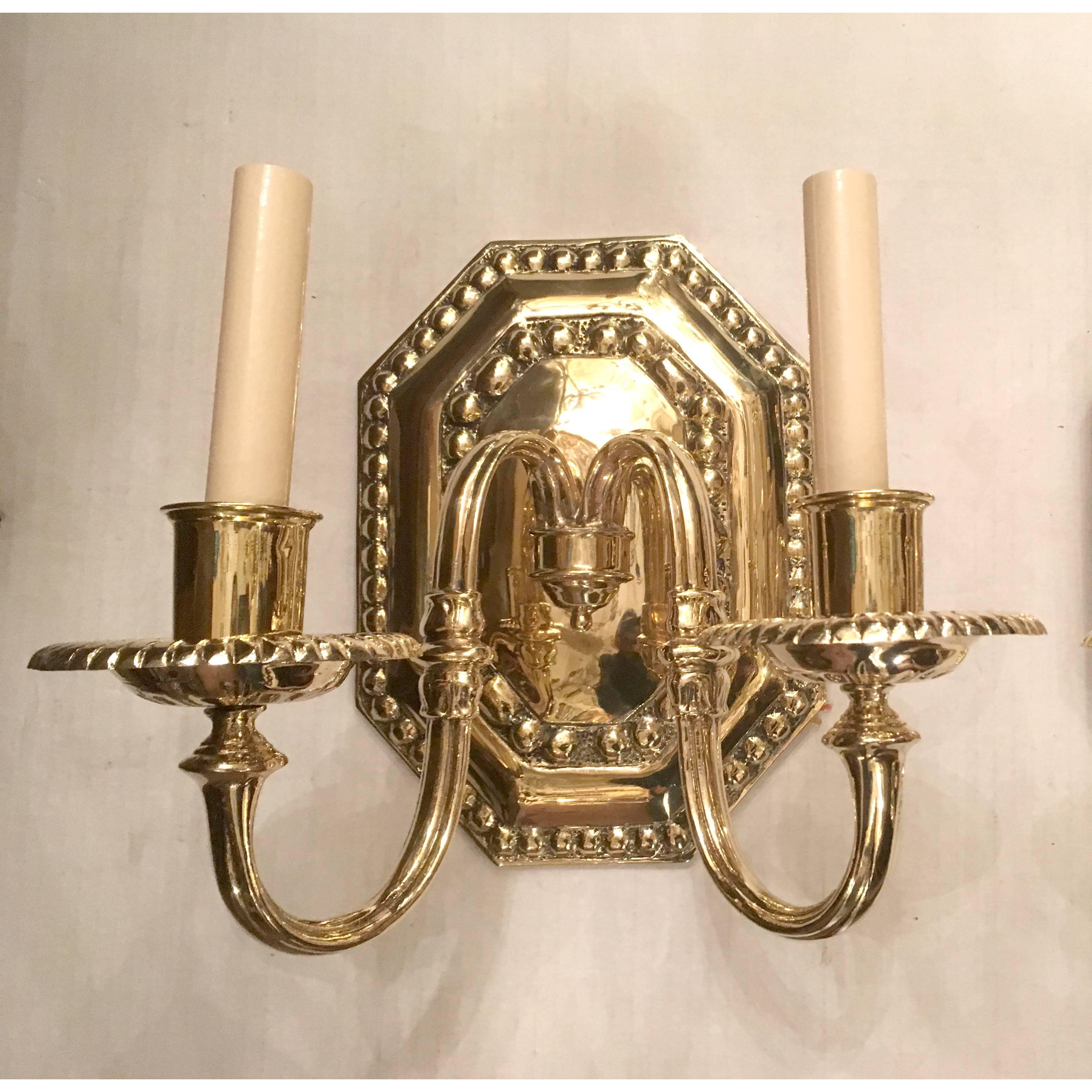 Set of 12 neoclassic bronze sconces, octagonal backplates, polished and lacquered finish. Italian, 1940s.