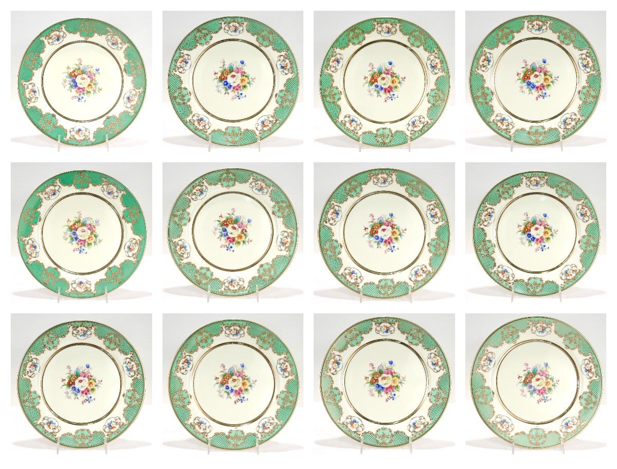 A fine set of 12 Noritake porcelain dinner plates.

With transfer painted polychrome flowers to the center & rim, green Rococo style decoration, and raised gold highlights.

(Labeled to the reverse with an old Seidenberg sticker pricing the set at