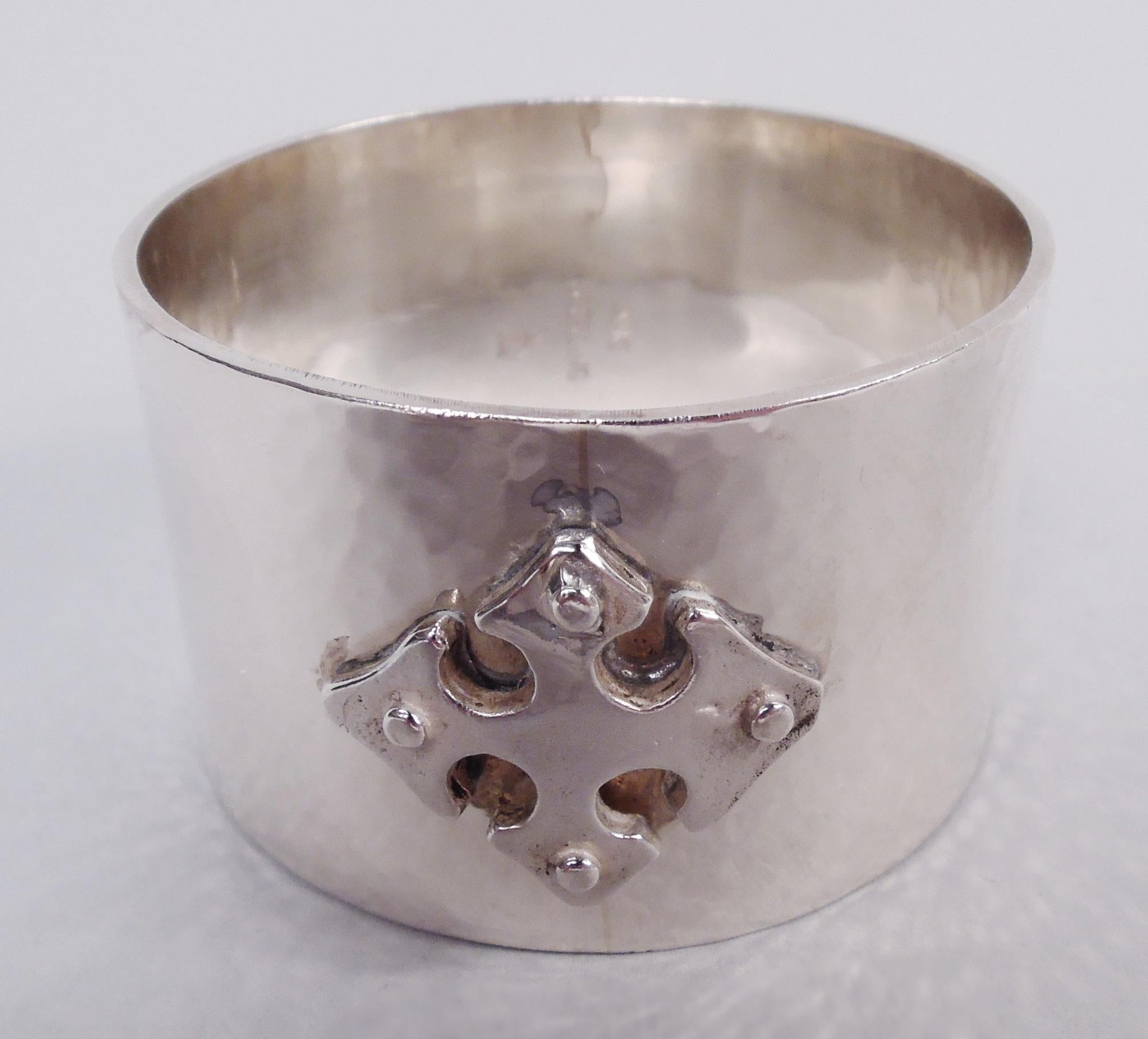 Twelve Crusader sterling silver napkin rings. Made by Old Newbury Crafters in Massachusetts. Each: Hand-hammered with stud-mounted cross. A desirable set in the Gothic Craftsman pattern that was first produced in 1972. Fully marked including maker’s
