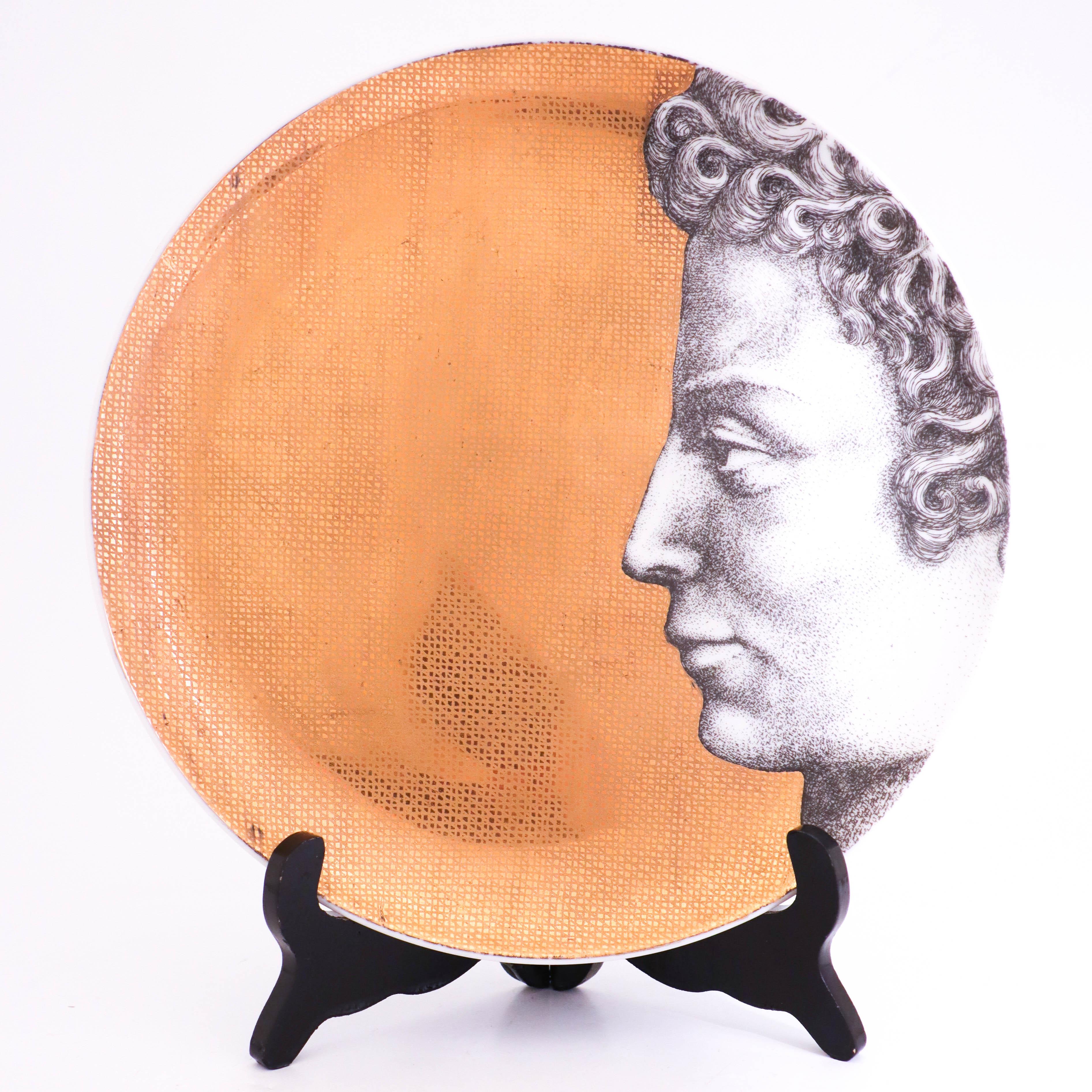 12 plates of model Adamo (Adam) designed by Piero Fornasetti in the 1950s. Piero Fornasetti created one set of Adam and one set of Eva containing 12 plates each. These plates are 26 cm in diameter and in very good condition, there might appear a few