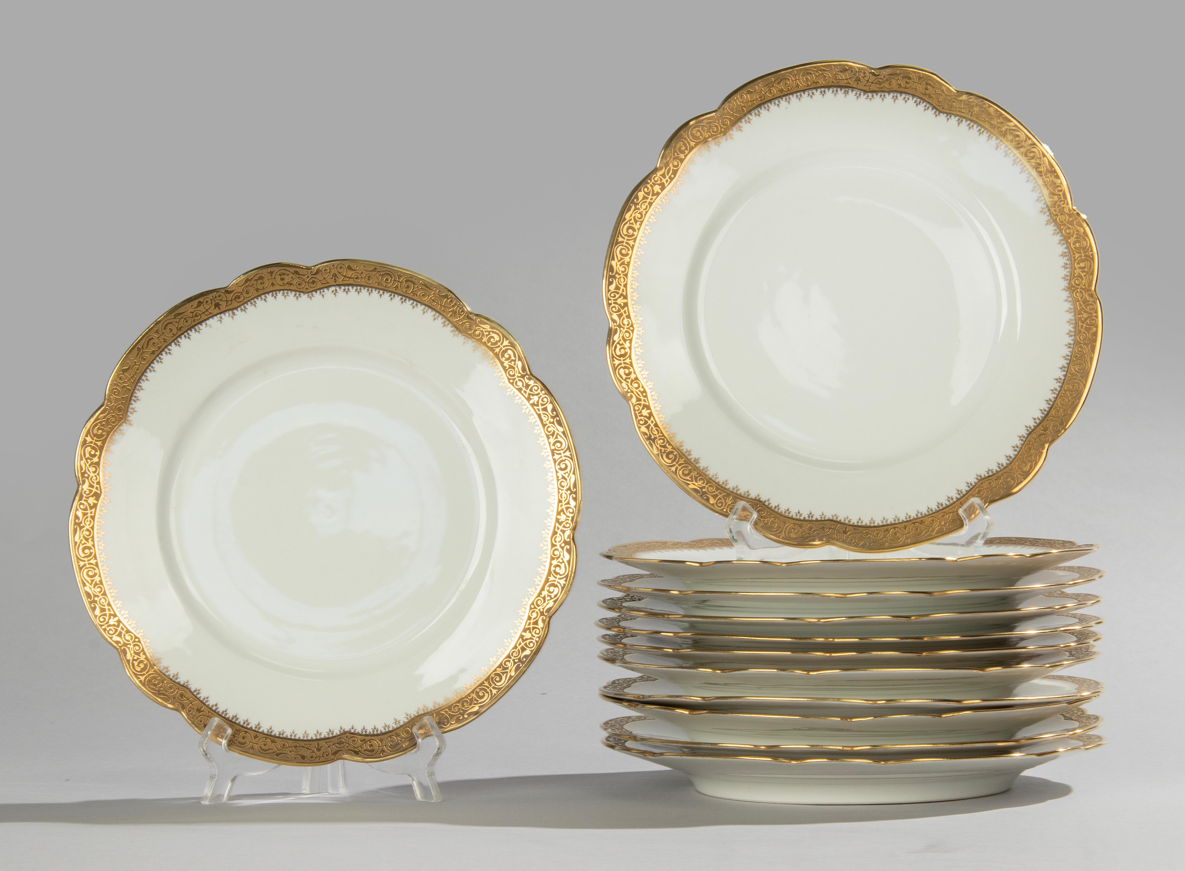 A beautiful set of 12 porcelain dinner plates, presumably from the French brand Limoges. 
The plates are beautifully decorated with inlaid gold edges.
The plates are all marked with a mark of A. Taillardat et Fils, Paris. This is the store where it