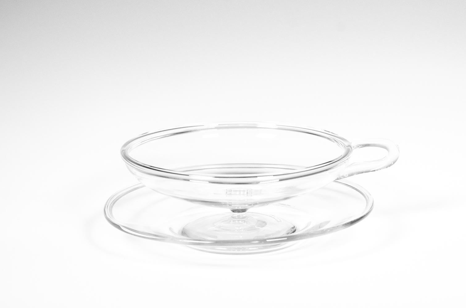 This set of 12 dessert coupes are the perfect addition to any table setting. Crafted from crystal, each coupe features a unique handle, that are embellished with a folded rim on both the bowl and plate. This timeless set can be used from first