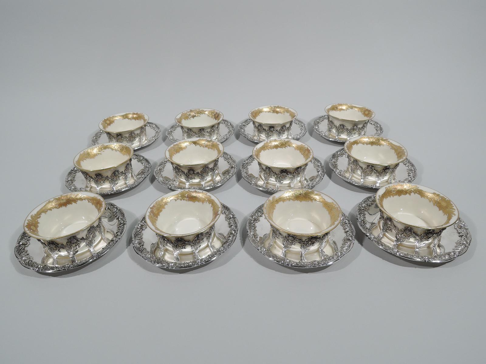 Set of 12 Chrysanthemum sterling silver bouillon bowl holders: Each: Open ring comprising joined stem flowers mounted to underplate with classic rim border comprising alternating flower heads and shaggy leaves. Fully marked including pattern no.