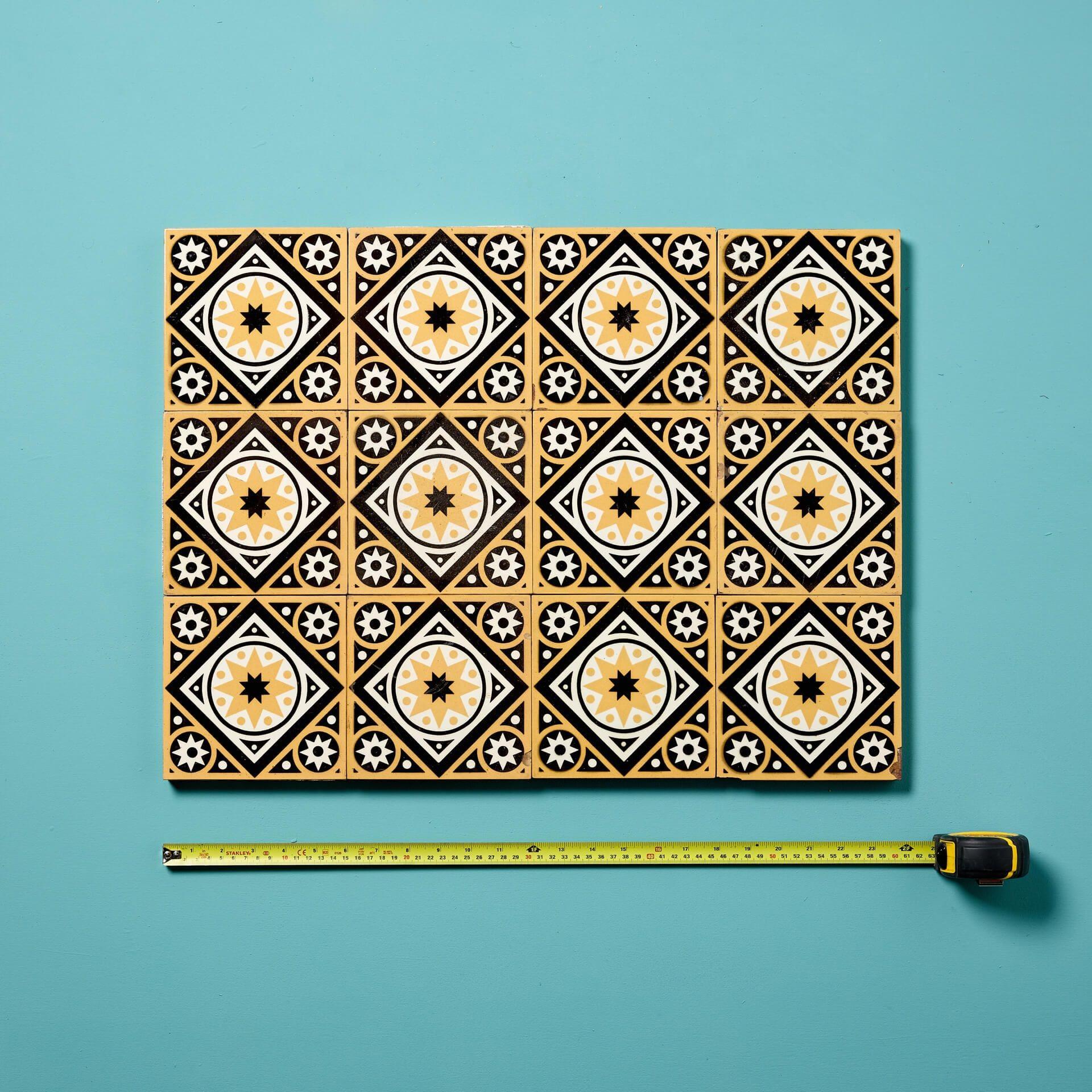 A set of 12 reclaimed glazed encaustic floor tiles by W Godwin, Lugwardine.

Dating from the late 19th century, these reclaimed floor tiles are of Pugin style in vibrant white and yellow with a moody black background, perfect for use as an